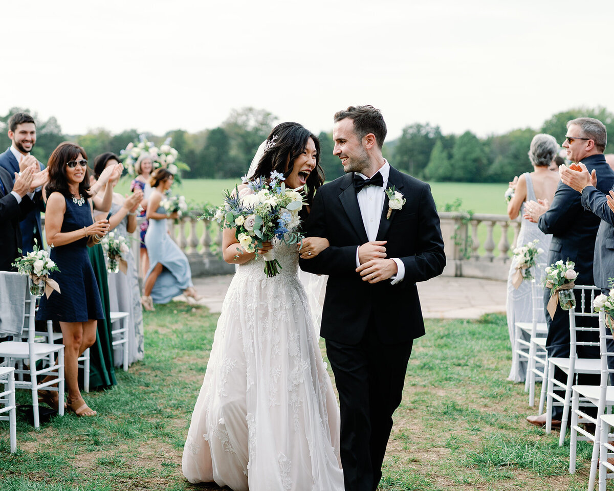 Bride and groom happily walk down the aisle after ceremony