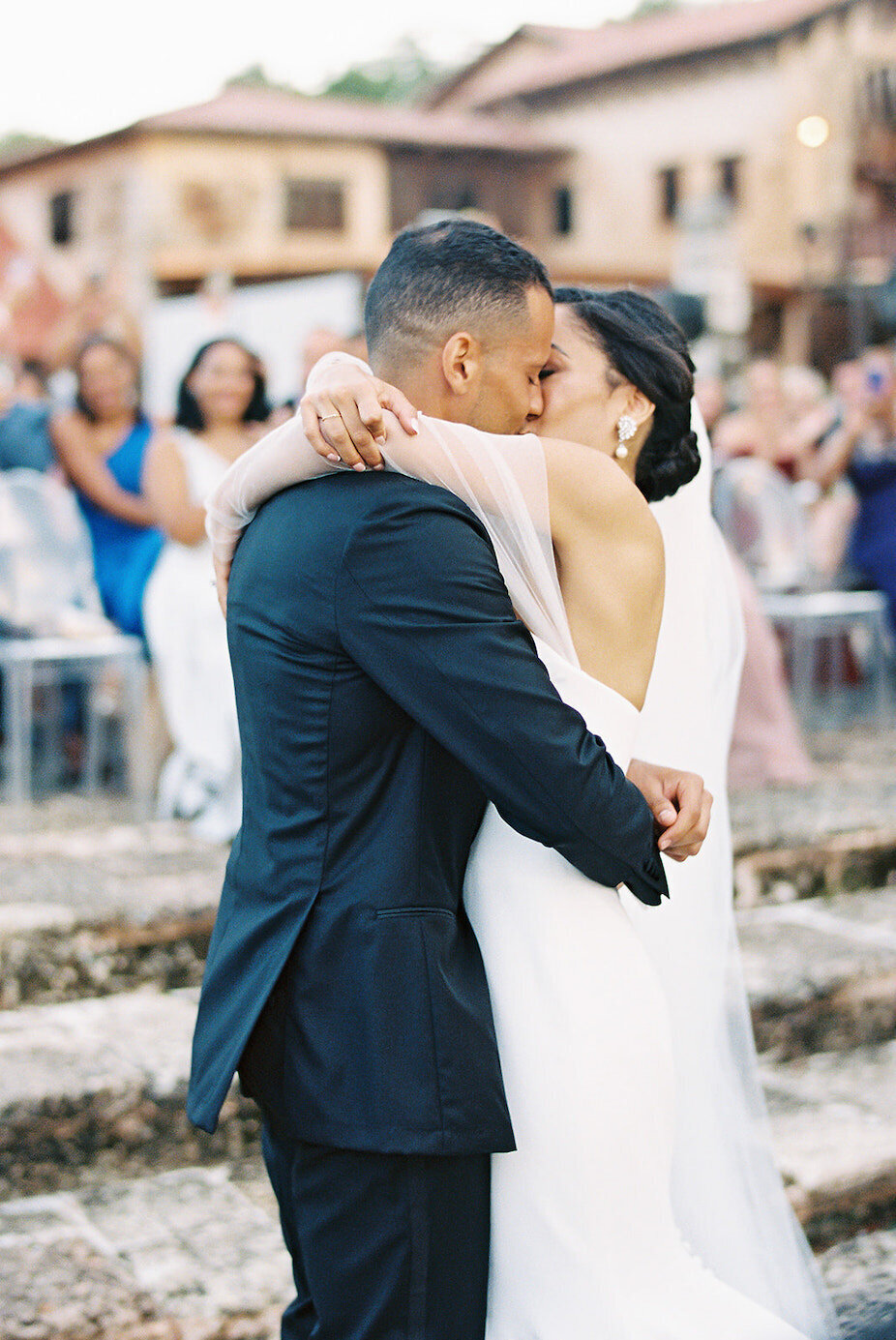 Bride and groom kissing during their outdoor destination wedding