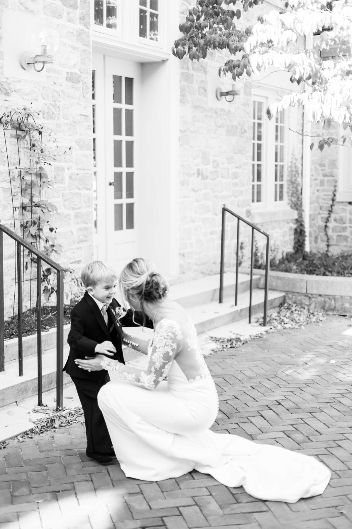 Bride bending down to talk to little boy at The Carrick House Wedding venue in Lexington, KY