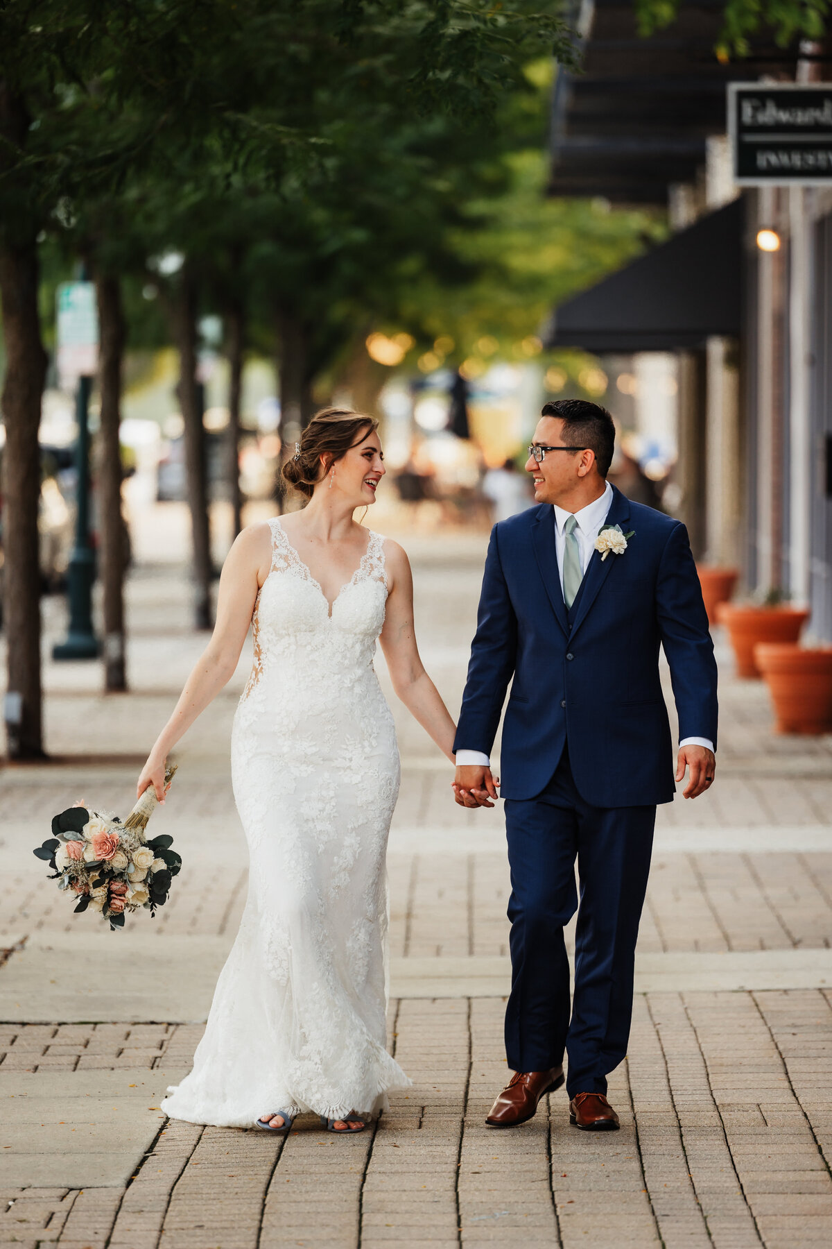 A wedding couple skip down the street in downtown Lemont.
