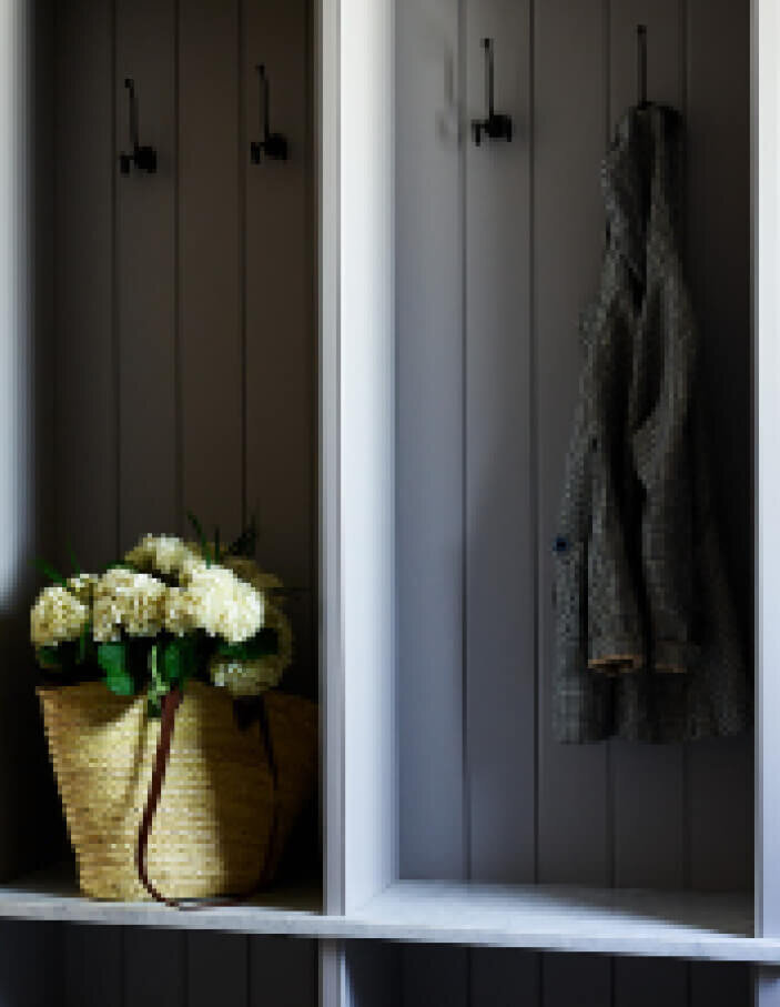 Marble bench and light grey custom cabinets in a classic mudroom interior design by Milton interior decorators, blending function with timeless architecture.