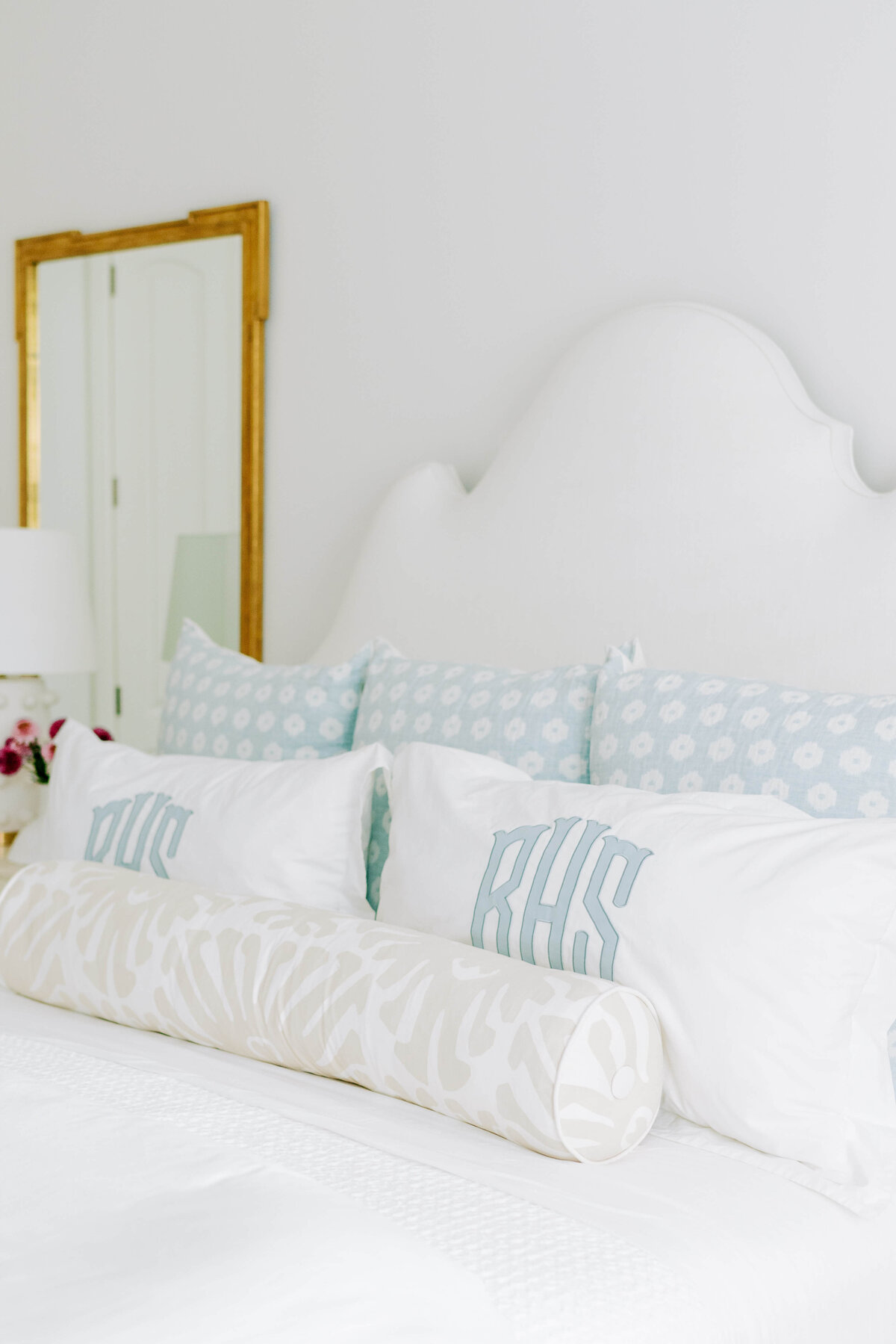 oyster creek studios hause white bed with blue pillows in bedroom