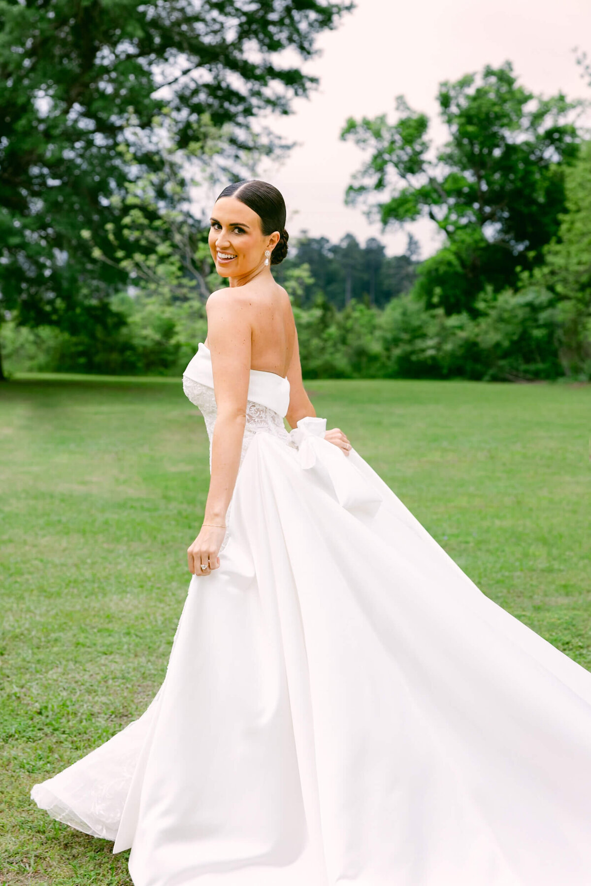 A wedding day portrait photo of the bride in her white wedding dress