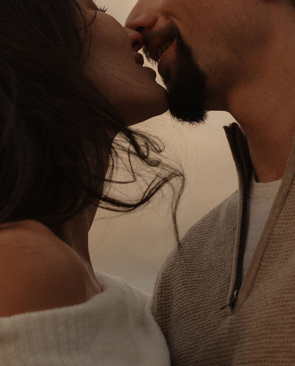 couple kissing while the wind gently blows their hair at Smith Rock State Park