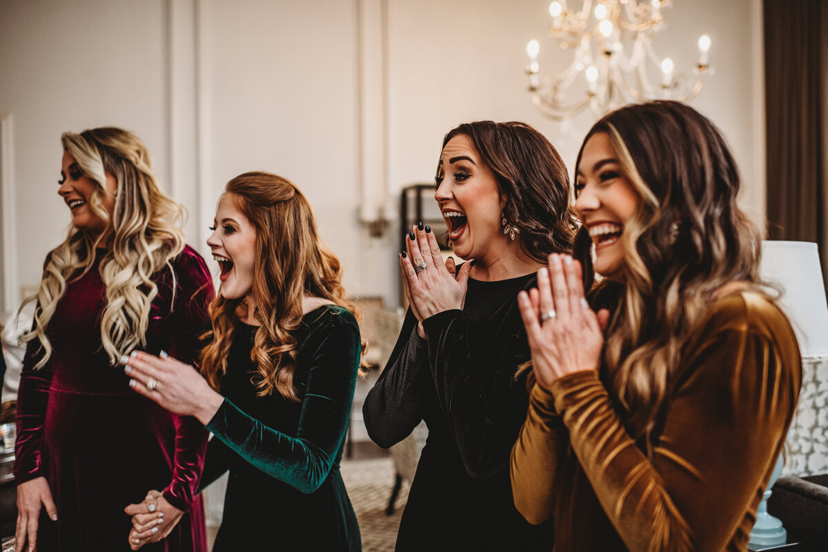 Bridesmaids in gem toned bridesmaids dresses react to seeing their bride for the first time captured by Baltimore wedding photographers