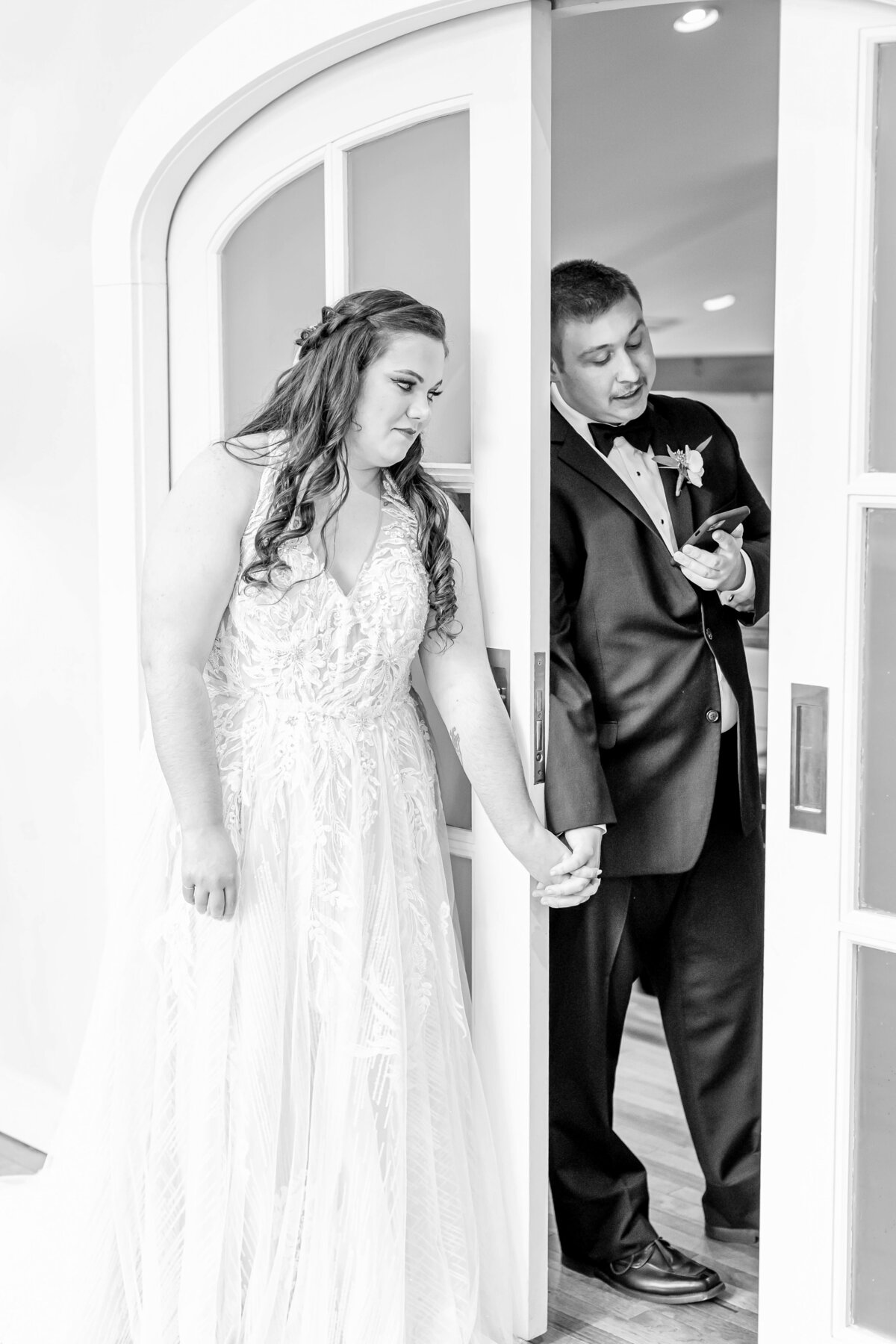 first look behind closed doors with bride and groom