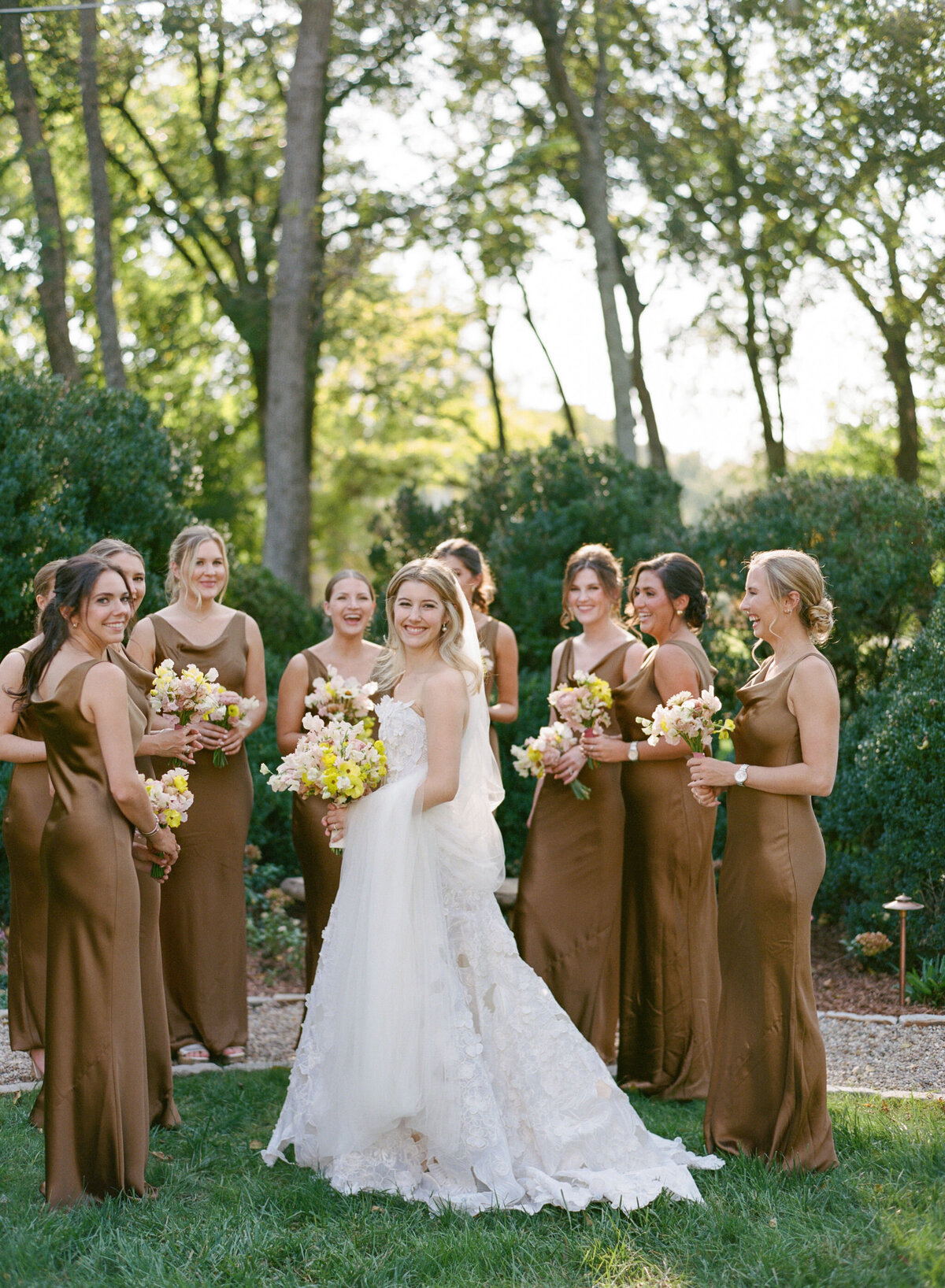 Product clustered bridal bouquet with sweet peas, local zinnias, and butterfly ranunculus. Elegant and simple bridal bouquet and bridal party bouquets with hues of blush and pops of yellow. Unique fall wedding design for private residence wedding in Nashville, TN. Bridal party wearing brown and wedding design with touches of brown. Design by Rosemary & Finch Floral Design in Nashville, TN.