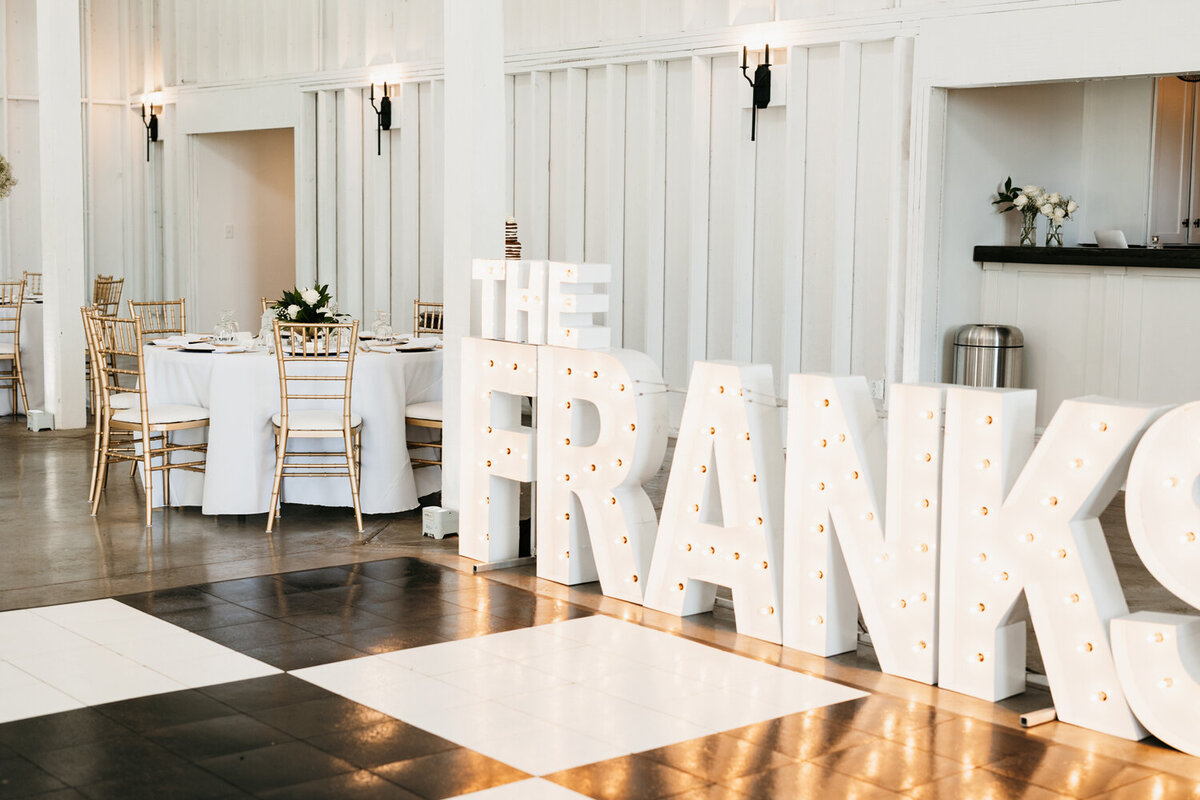 Elegant reception at Ashford Acres Inn in Cynthiana, KY, showcasing sophisticated marquee letters with the couple’s last name.