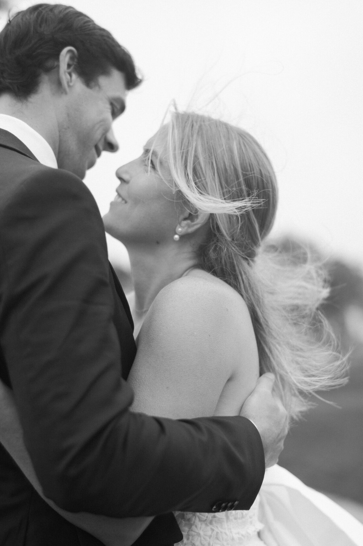 The bride and groom gaze into each other’s eyes, their foreheads nearly touching