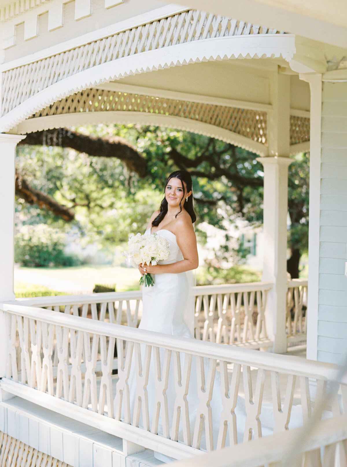 A timeless bridal portrait set against the backdrop of the 1891 Victorian mansion, the John Nickerson House in Lafayette, LA, beautifully captured on film by Morgan Alysse, Louisiana film photographer.