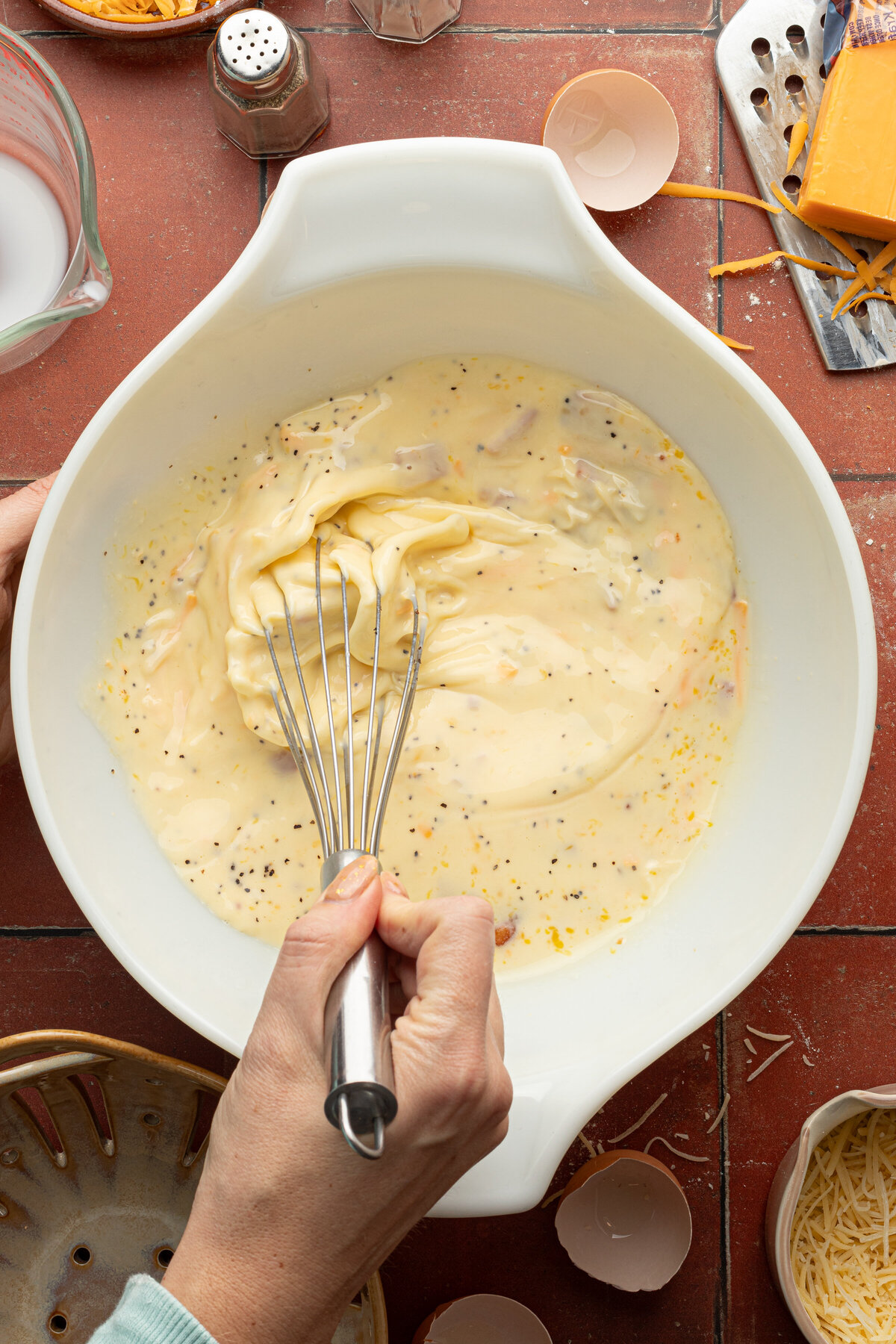 an egg mixture being whisked in a bowl
