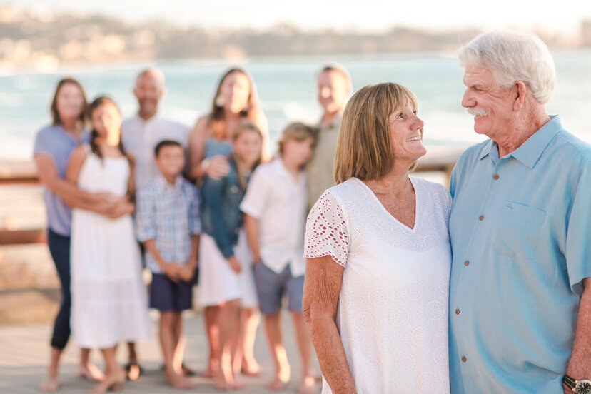 grandparents-with-family-in-background-Scripps-Pier-San-Diego