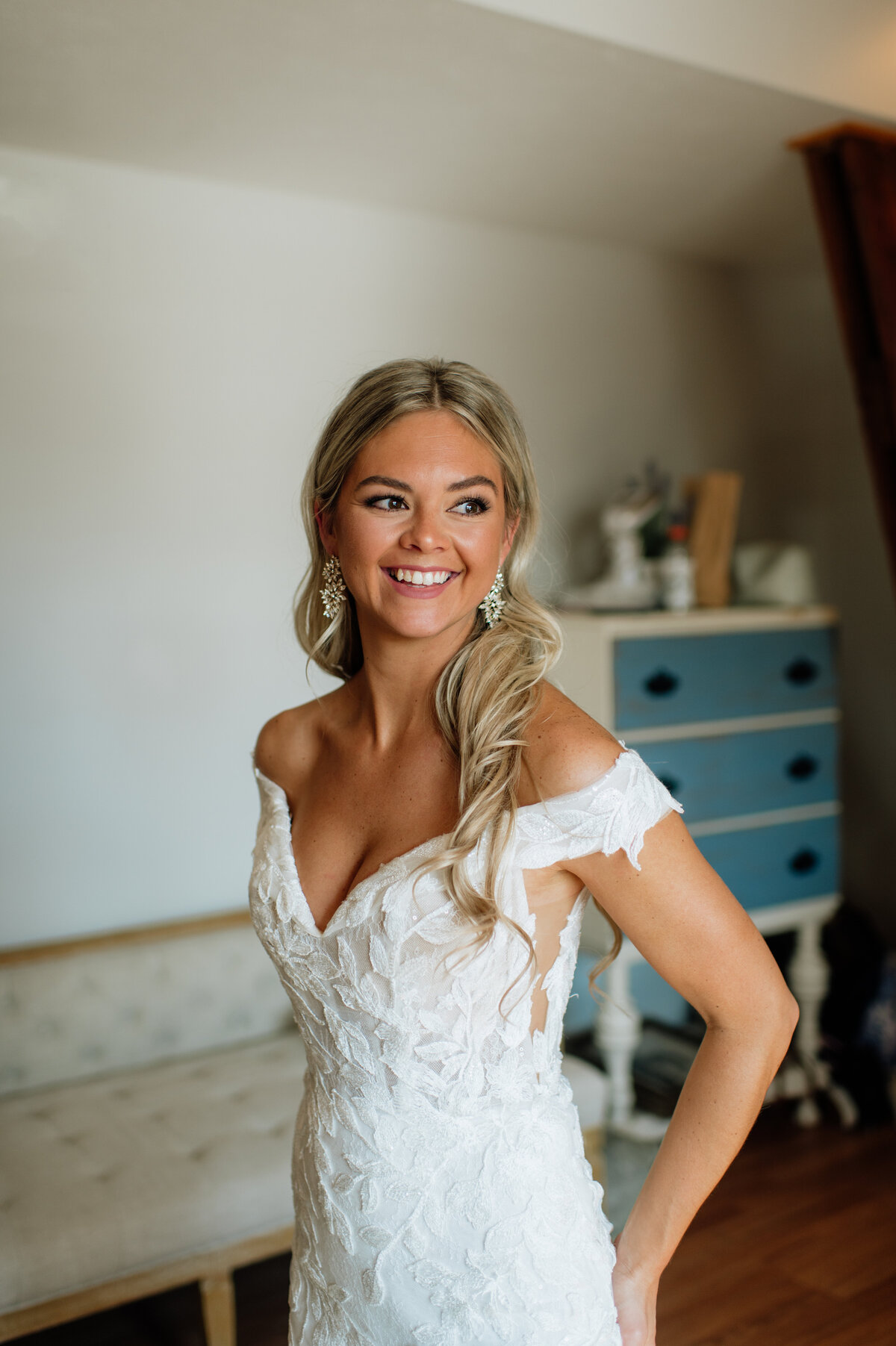 Bride smiling while getting ready before ceremony
