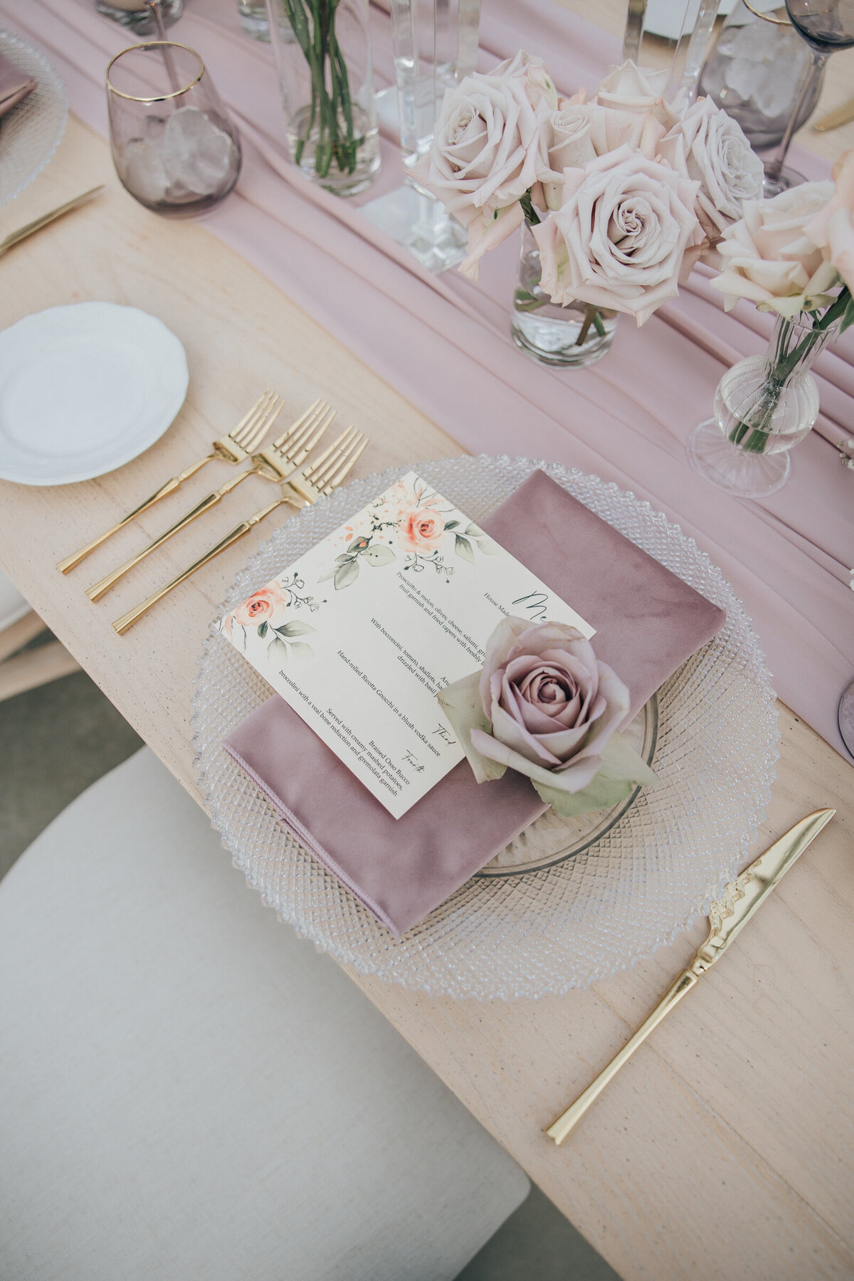 Crystal wedding plates with lavender serviettes and gold cutlery