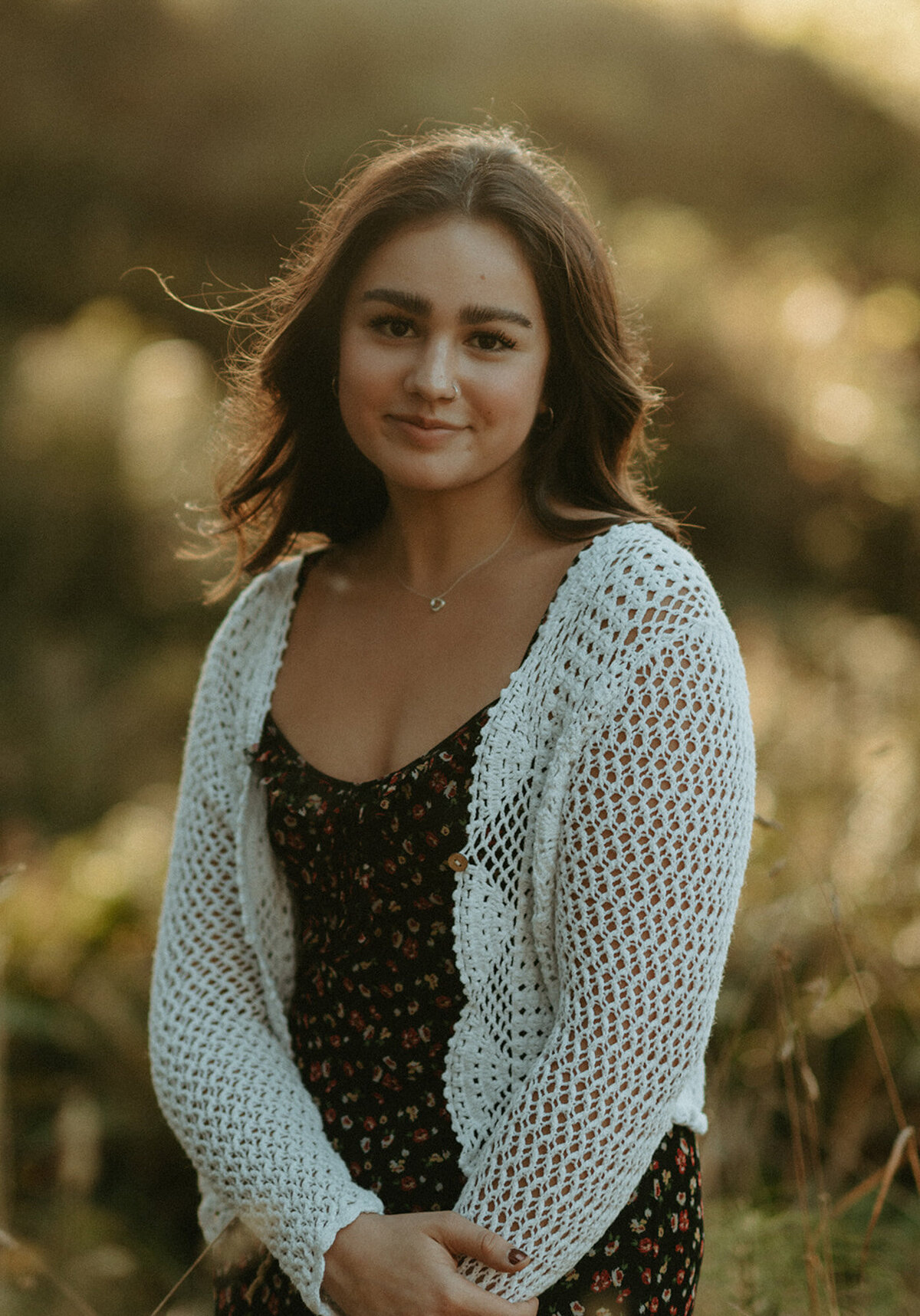 girl wearing floral dress and white sweater