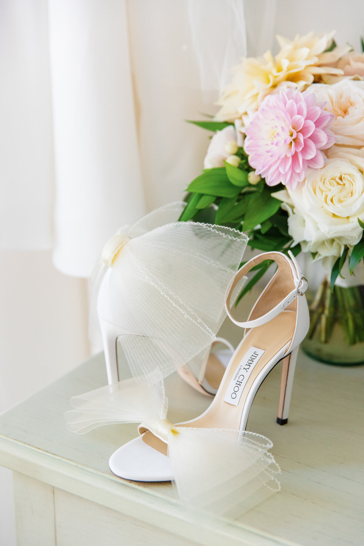 jimmy choo bow shoes styled with bride's bouquet and dress