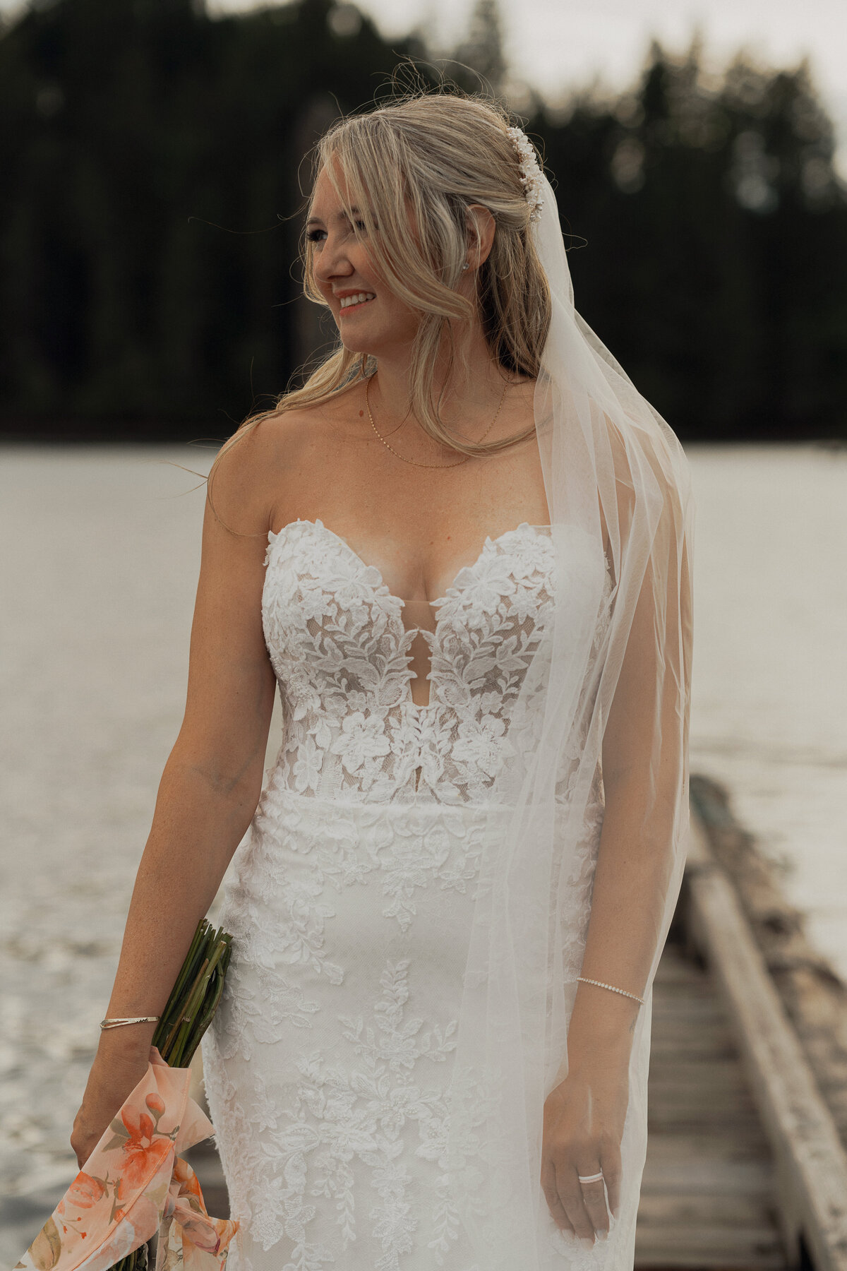 Bride and groom at comox lake at the fish and game club during her wedding portraits by latitude 49 photography