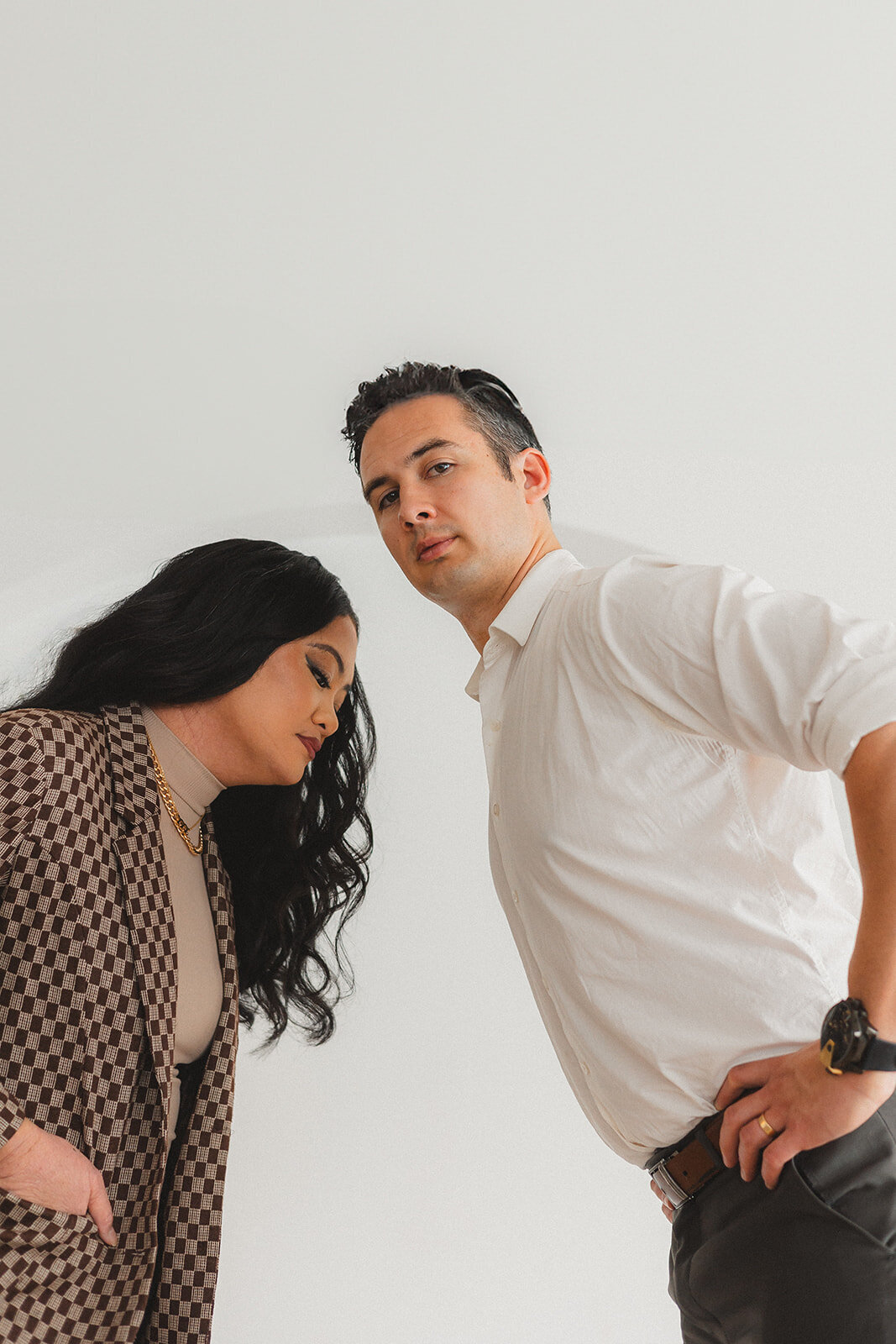 Two people lean towards the camera