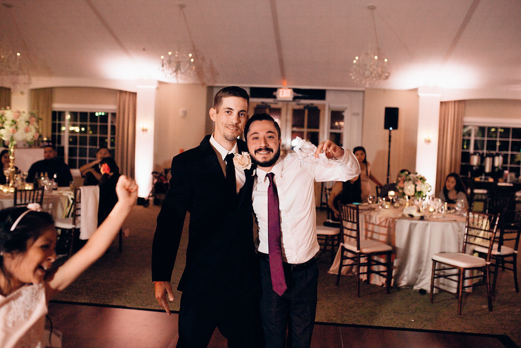 Wedding Photograph Of Groom In Black Suit And Man In Red Tie Loos Angeles