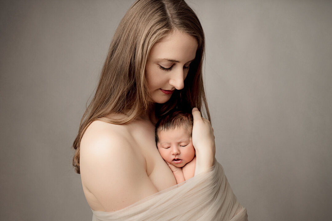 Grand Rapids Newborn Photography Mom Holding Baby Tight by For the Love of Photography