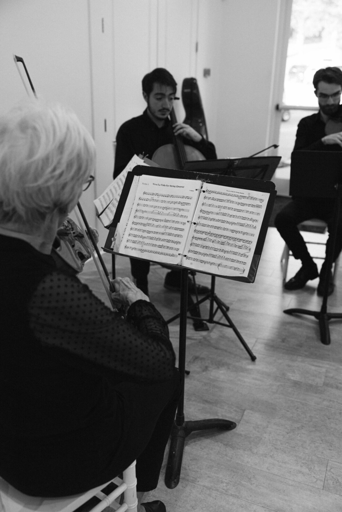 A black and white wedding photo a violin player during a wedding