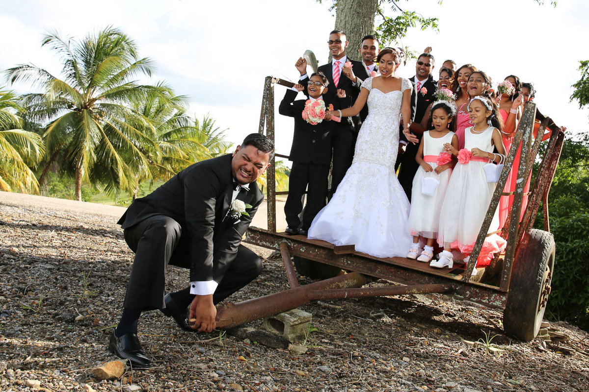 Fun, posed shot of groom with bride and wedding party. Photo by Ross Photography, Trinidad, W.I..