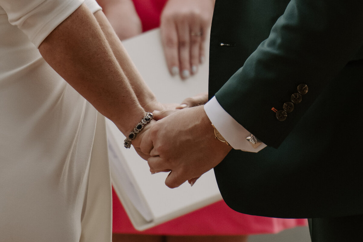 bride and groom holding hands