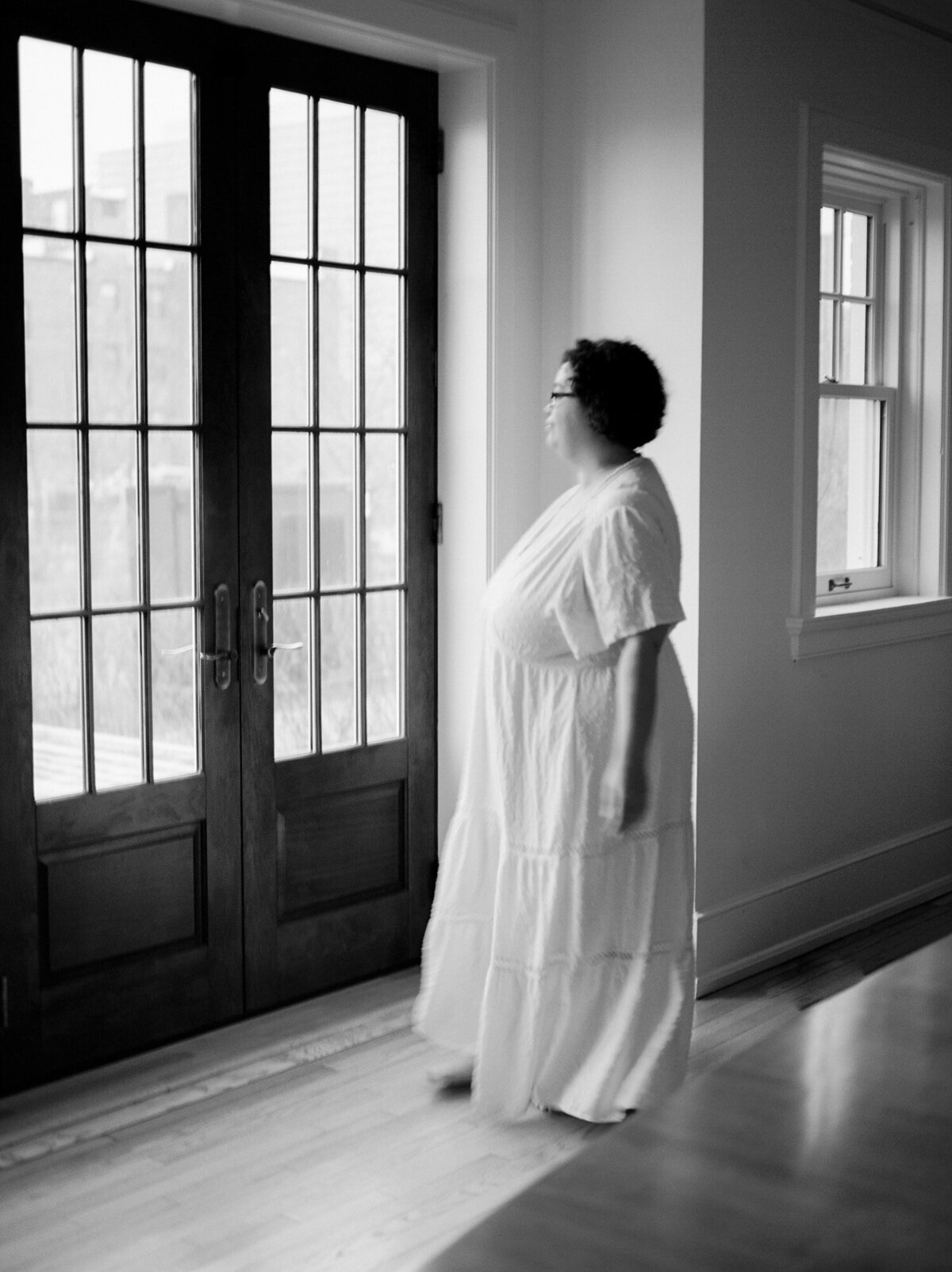 Movement film brand photography, woman in long white dress, historic doors with character ALEO Detroit