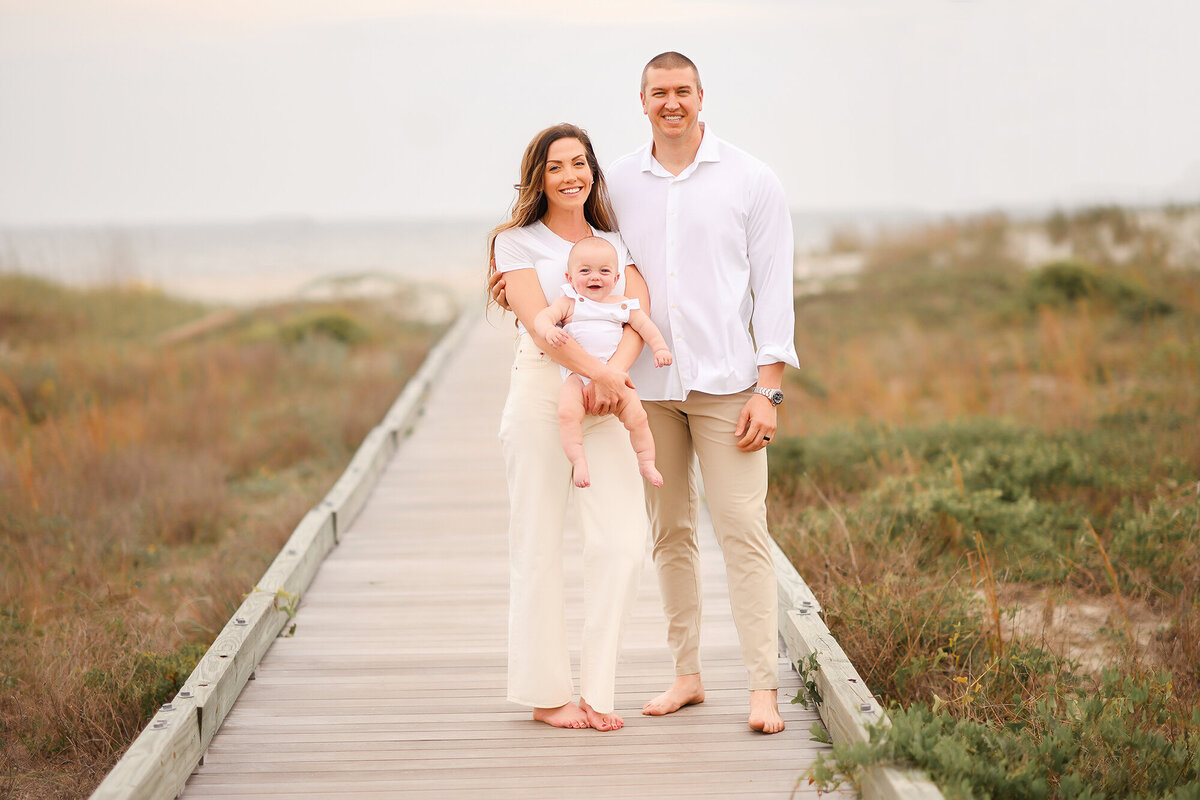 Family poses for Family Pictures on Isle of Palms beach in Charleston, SC.