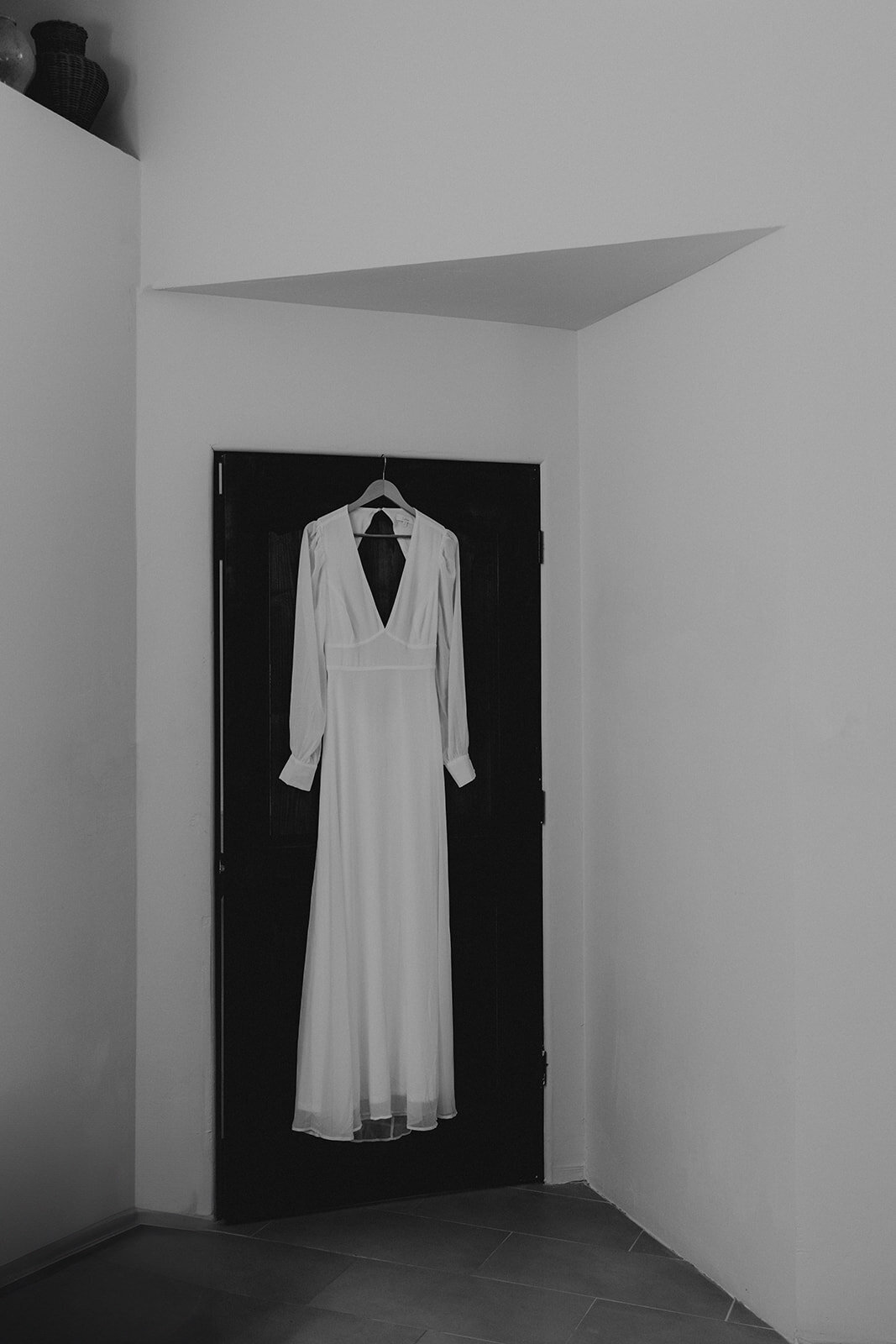 brides gown handing on a door