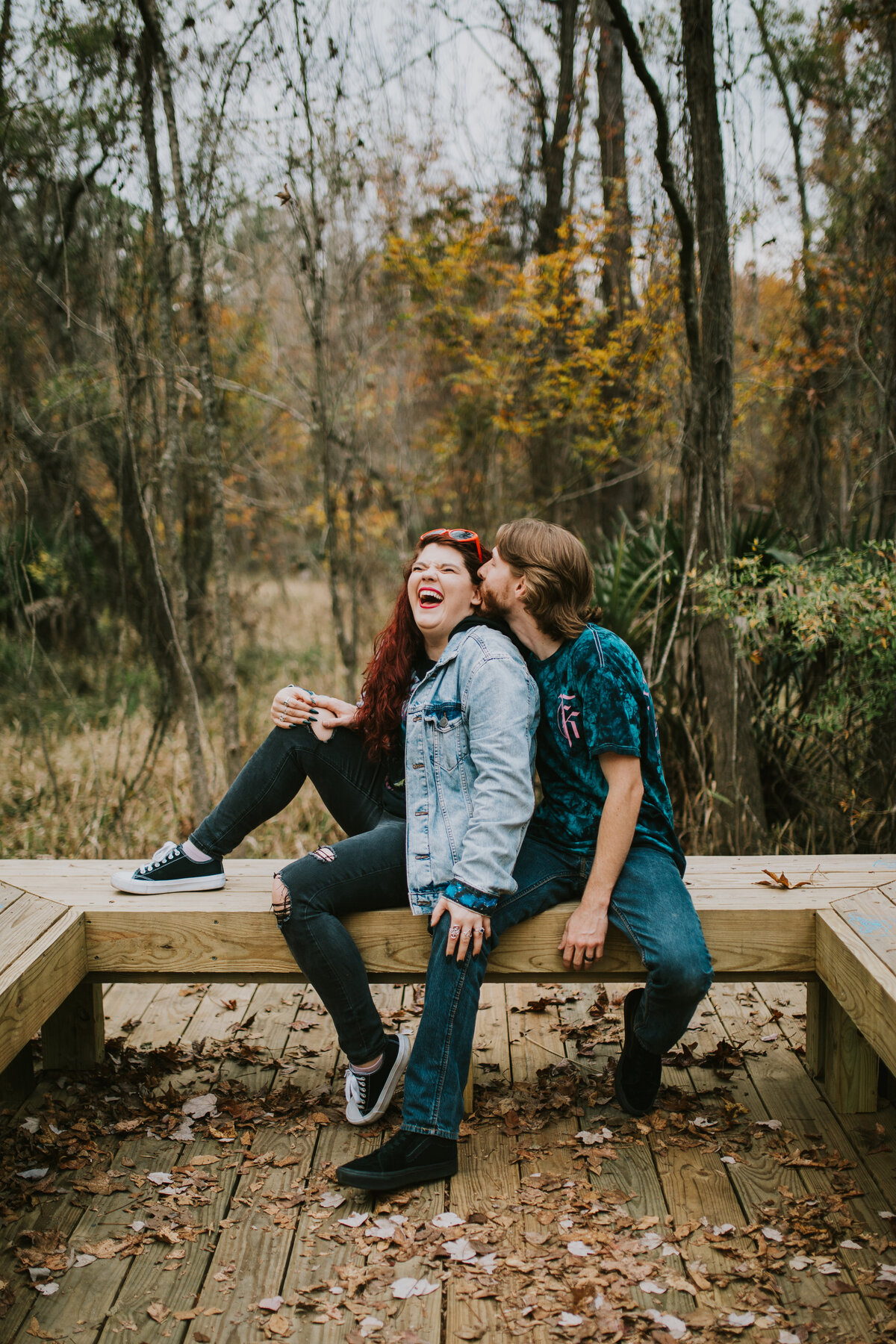 couple sitting on bench during engagement photos