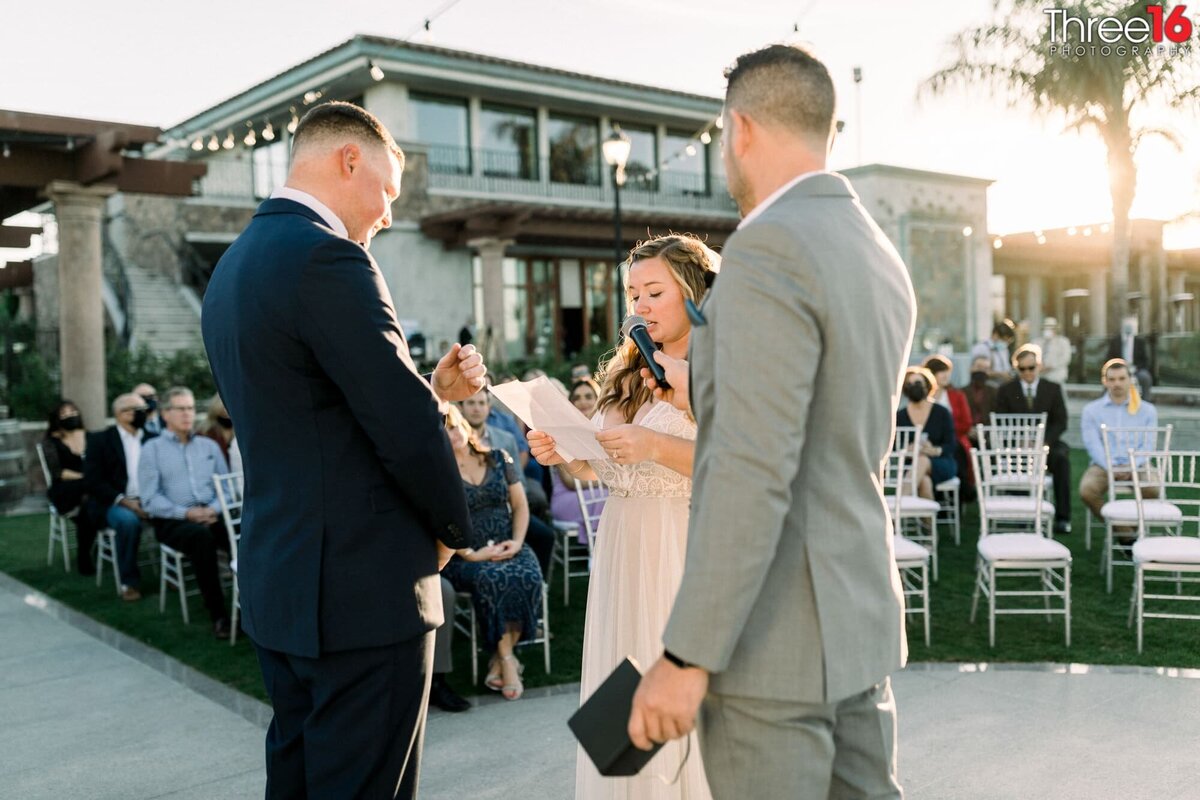 Bride reads her wedding vows to her Groom