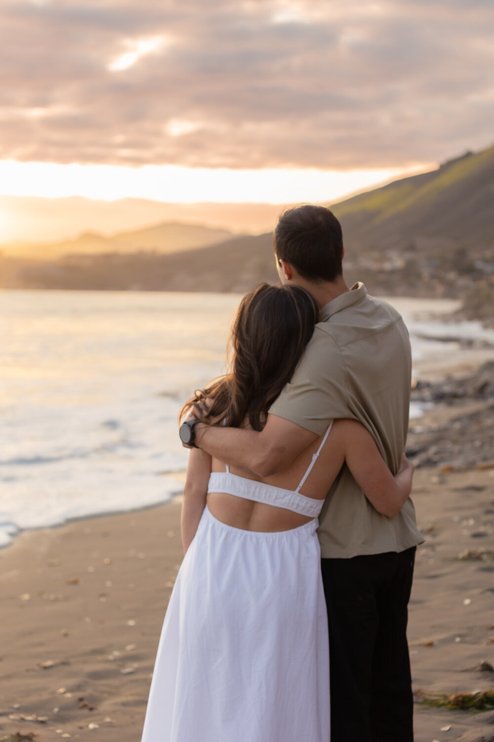 Couples Engagement Photos candid hug on beach in the Central Coast in Pismo Beach