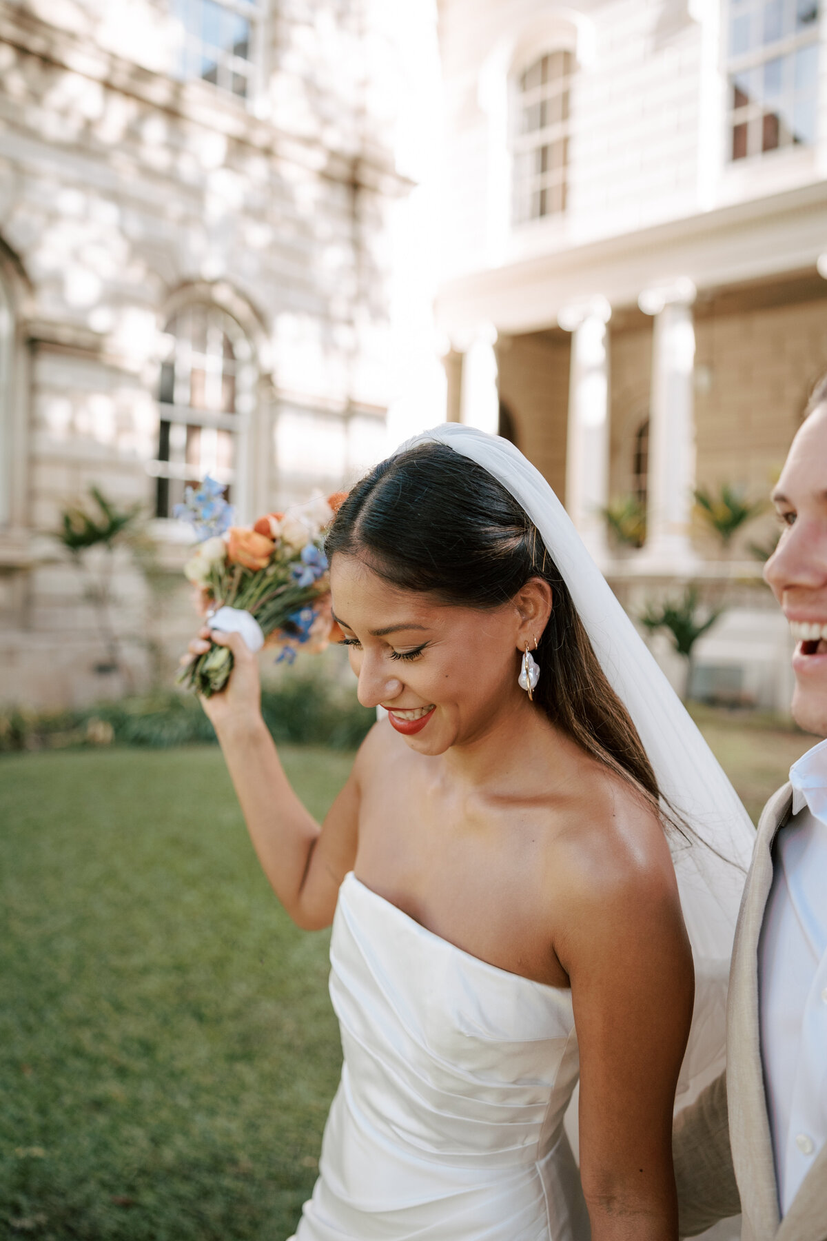 Lush, overflowing tropical flower arrangement lining the aisle, captured in a detailed film photo with a documentary wedding photography style — Carmel wedding photography by Kate Winters Photography.