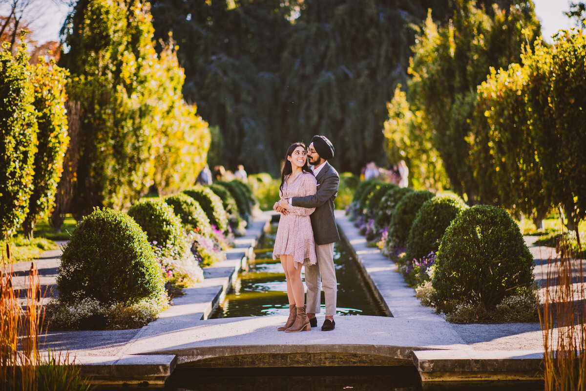Engaged sikh couple embracing at the untermyer gardens in yonkers ny