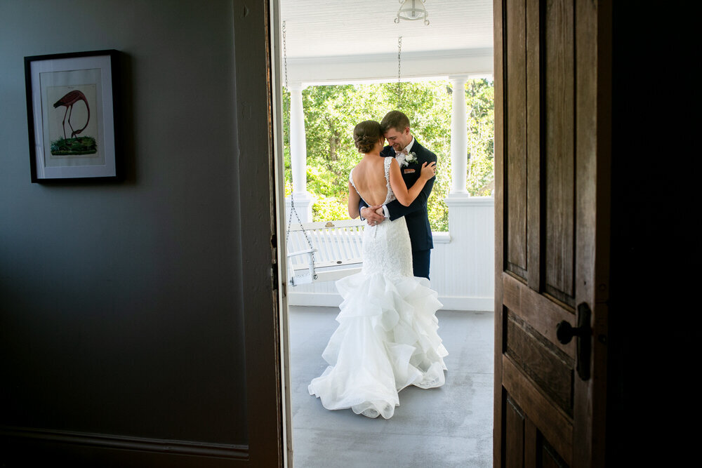 couple embraces through a doorway on their wedding day