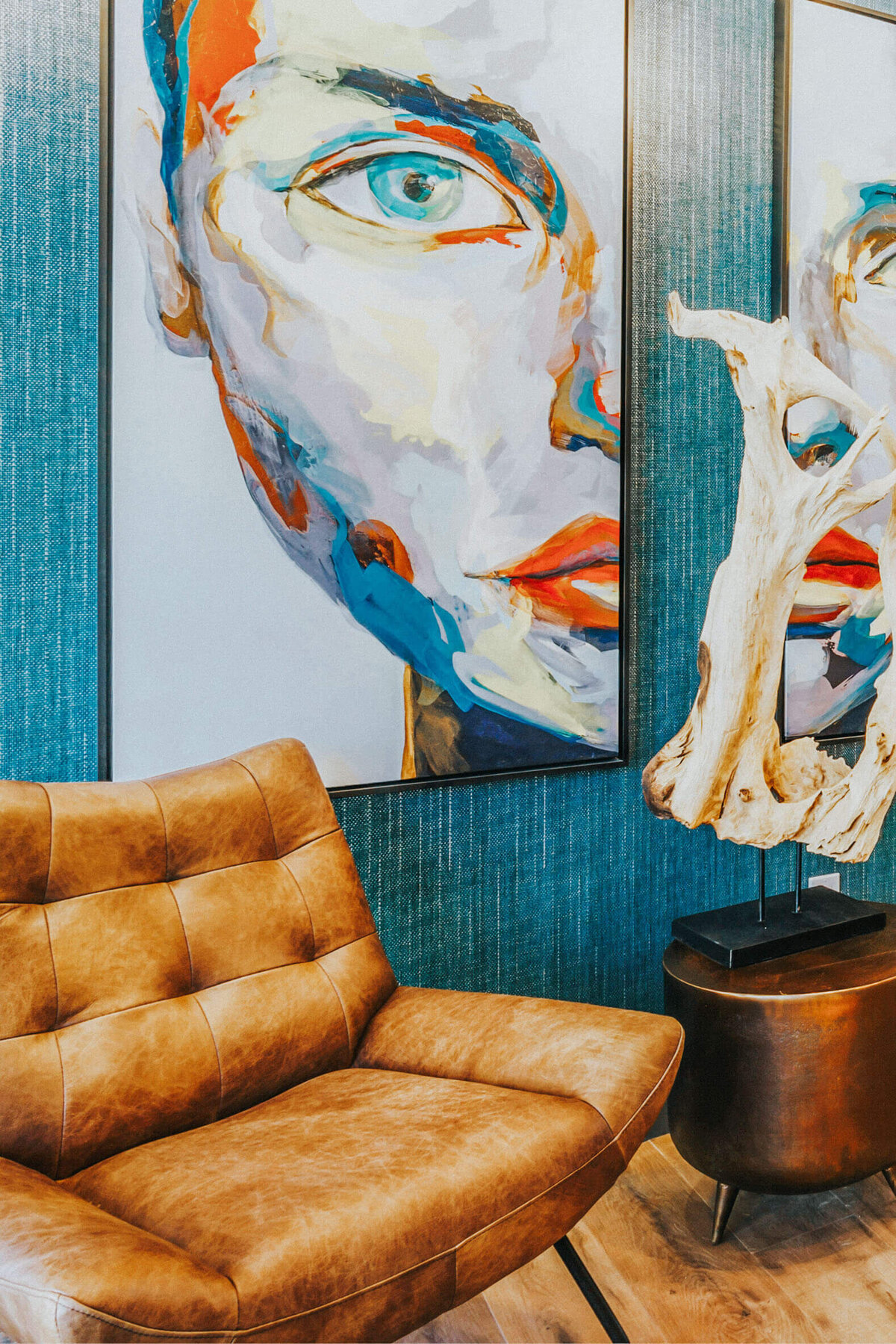Vibrant lounge at The Apex at Sky Valley with abstract portraits, leather chairs, and modern decor.