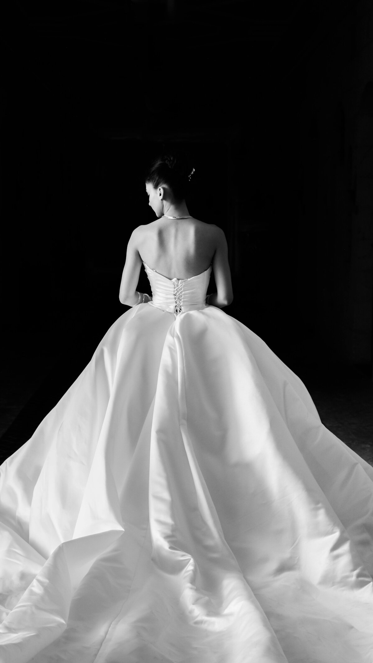 View of the back of wedding gown, large train in satin