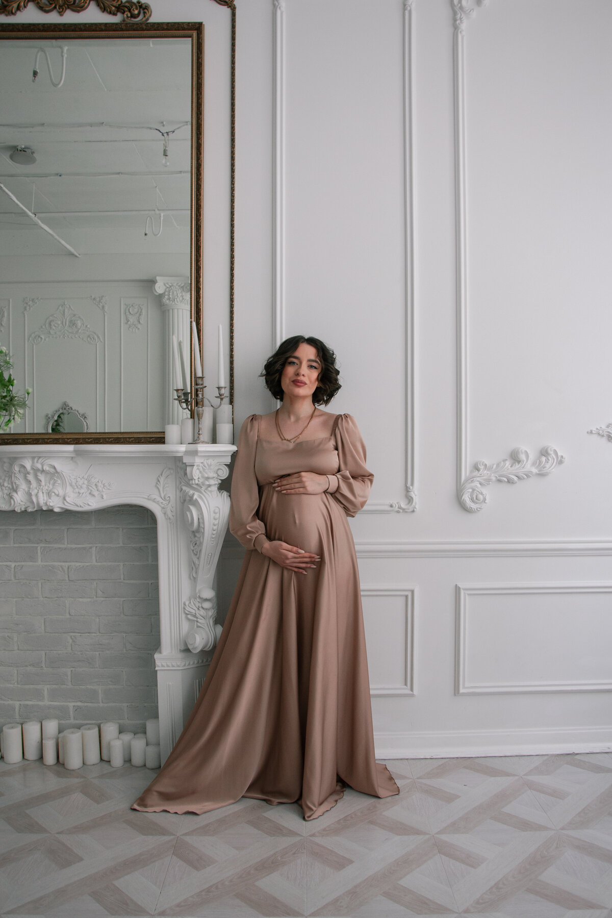 pregnant-woman-standing-front-fireplace