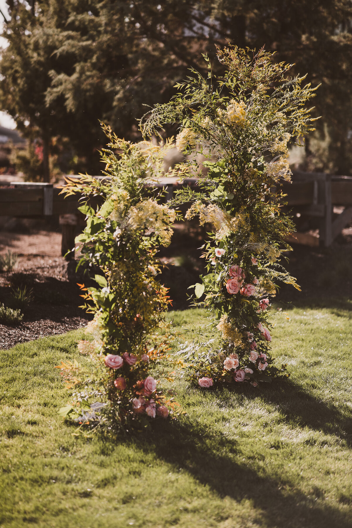 Romantic and lush asymmetrical floral arch wedding ceremony