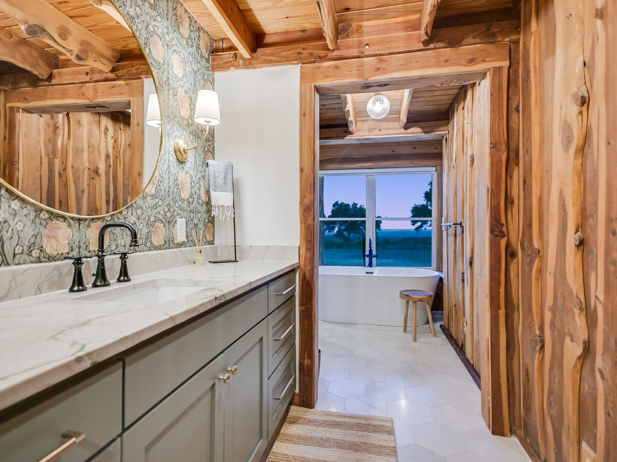 Main bathroom with decorative wall and marble counter tops