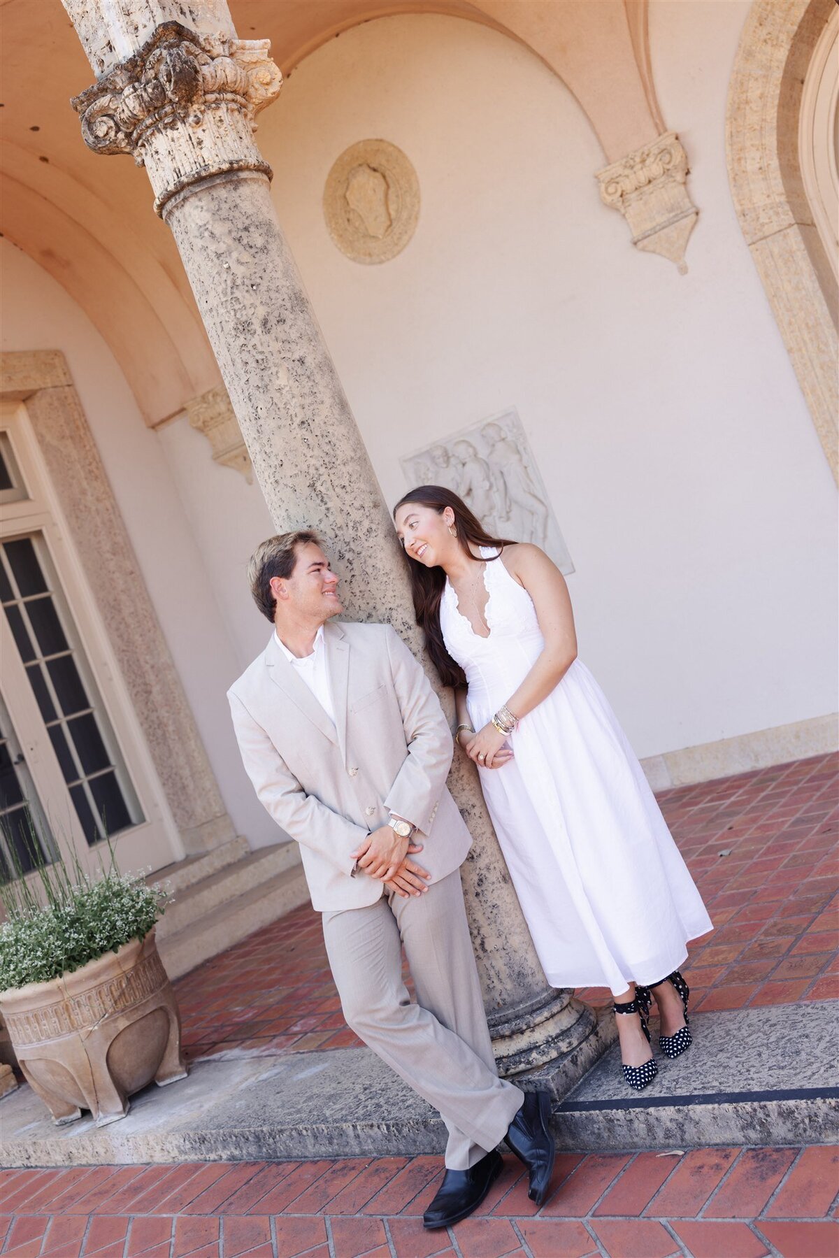 flirty couple portrait leaning column texas estate