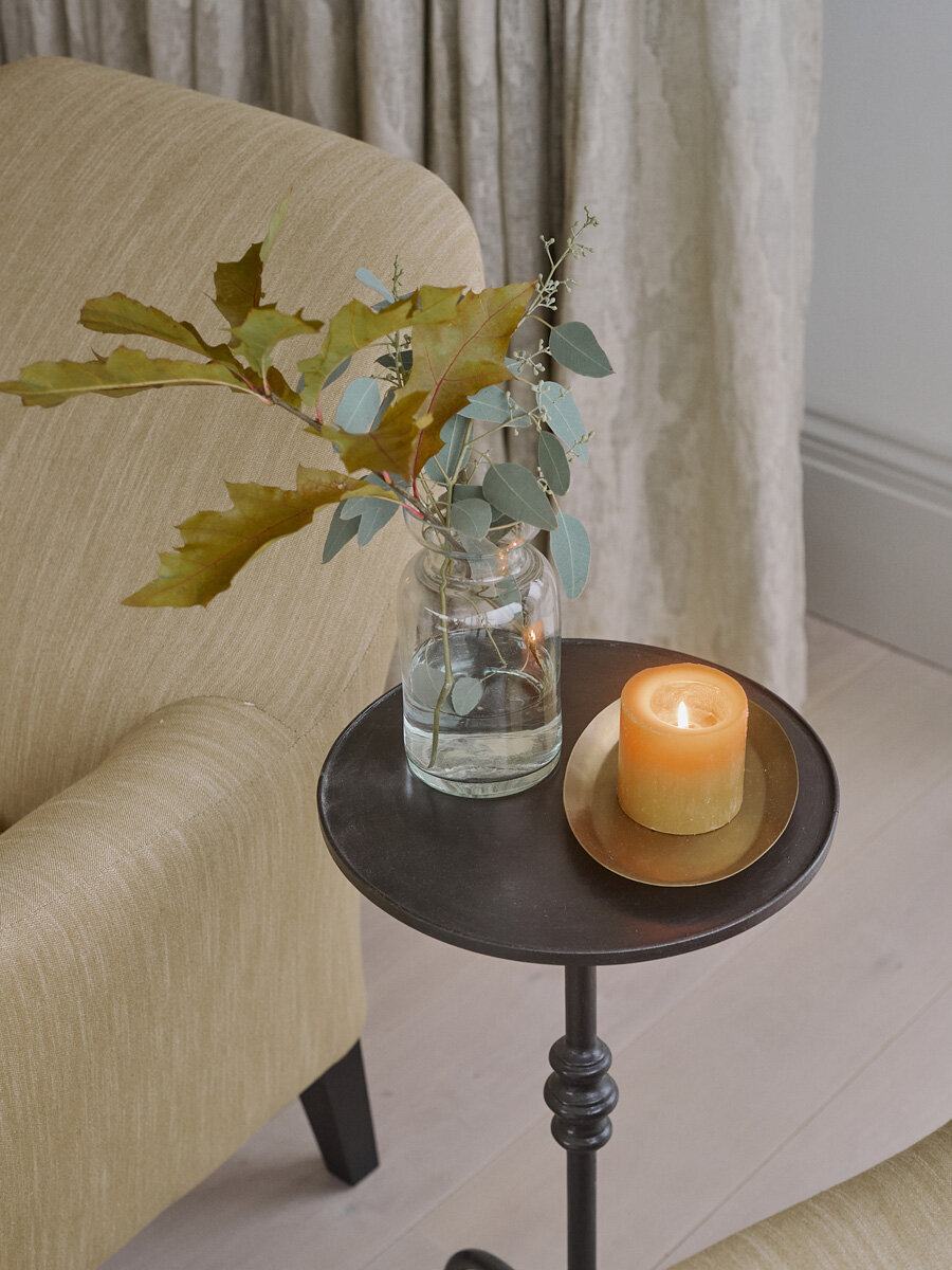 Sitting area in coastal Snowdonia home with detail of warm candle