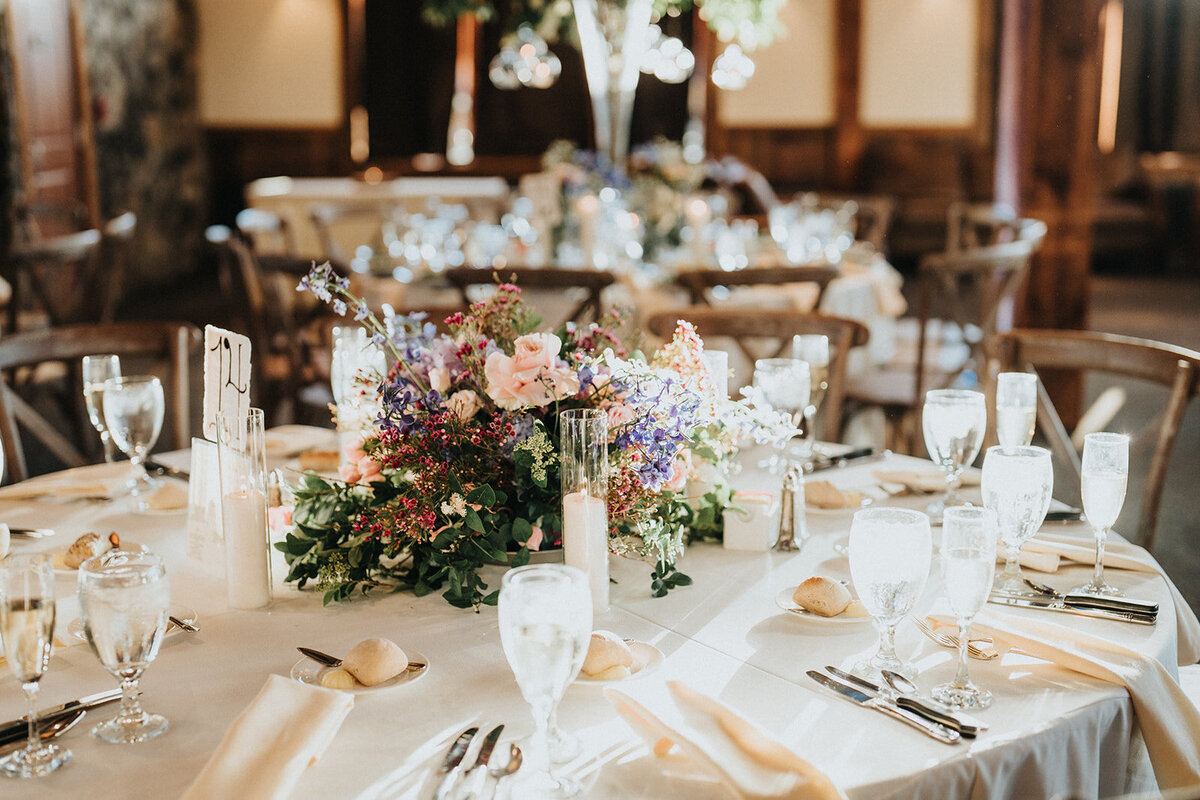 Reception table decorated with a flower centerpiece at Mountain Creek Resort