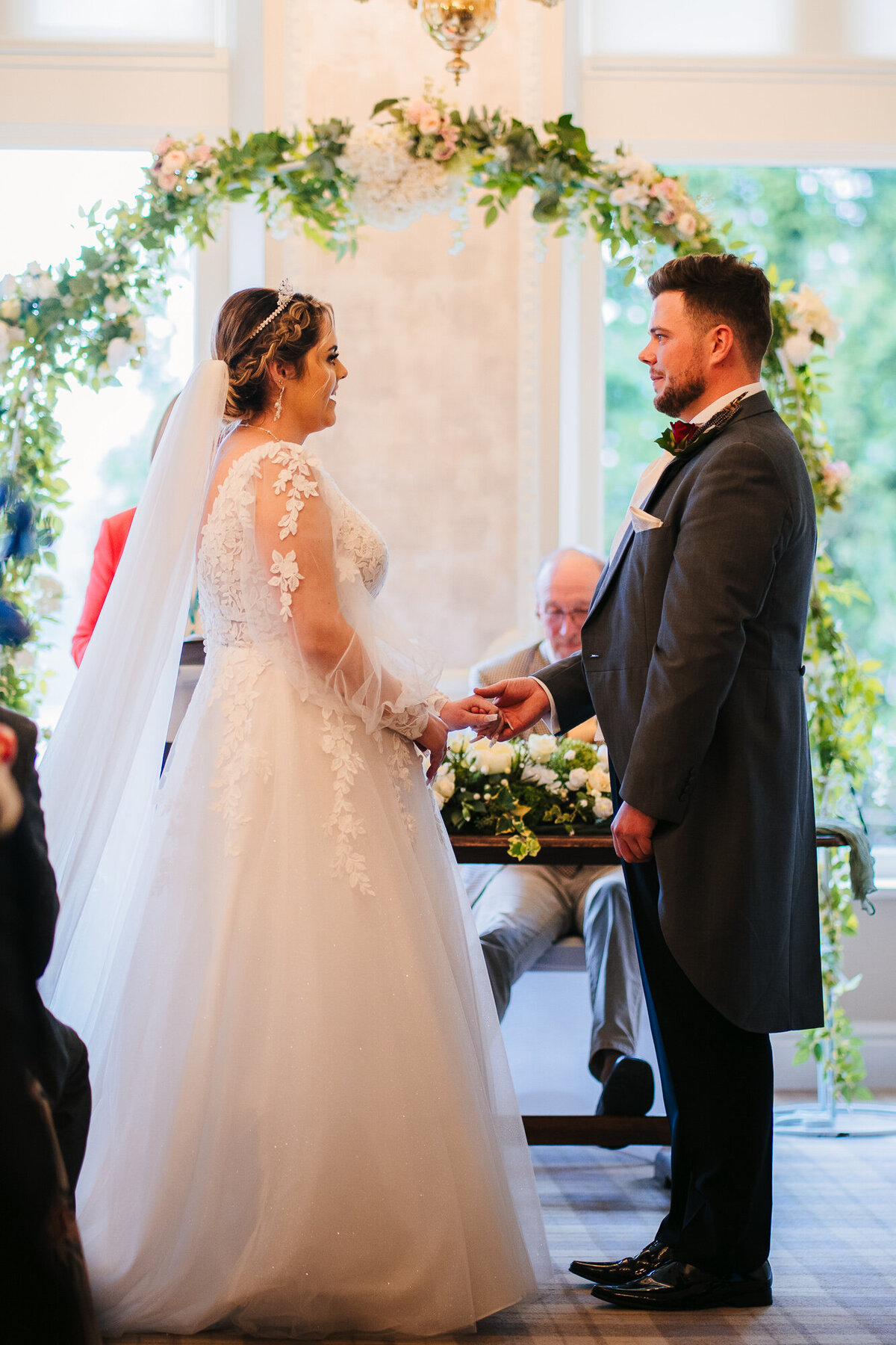 Groom placing ring on bride at Merewood Country House Hotel in the Lake District takne by wedding photographer Anthony Horseman