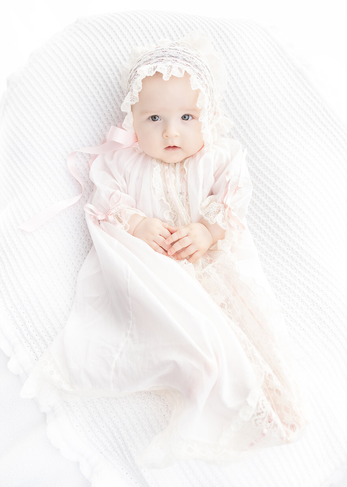 4 month old baby girl photographed in vintage heirloom christening gown in studio