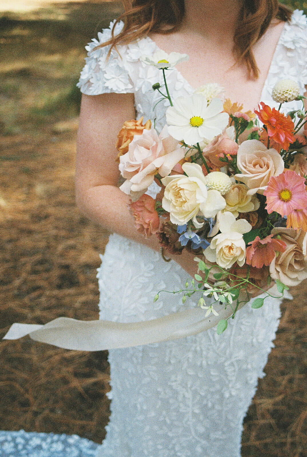 A close up of a bride holding a bouquet of flowers.