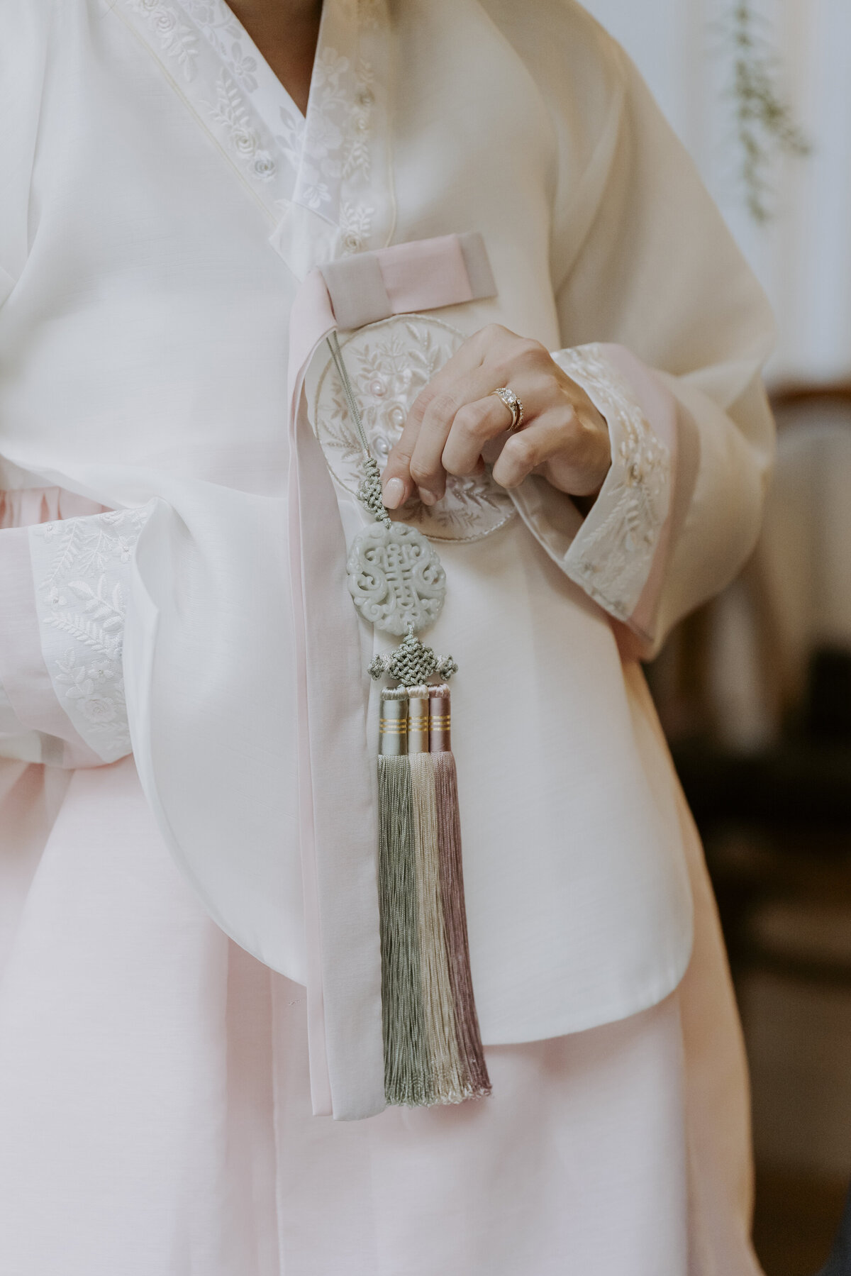 the bride's pink hanbok and a traditional korean accessory
