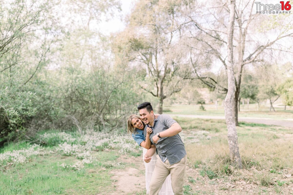 Bride to be tickles her Groom during engagement session