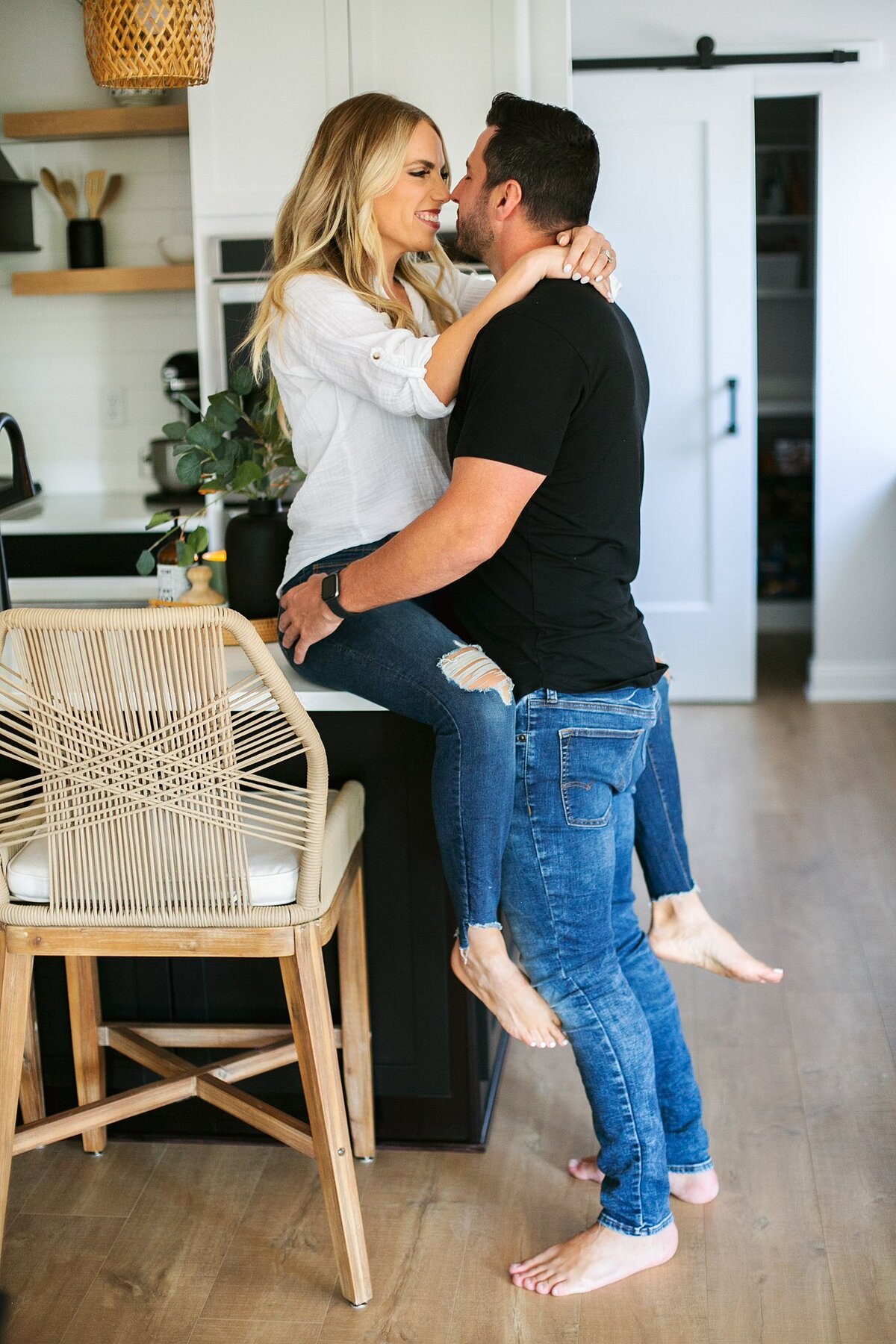 a-husband-and-wife-embracing-as-they-smile-inside-a-stunning-Brownsburg-Indiana-home-during-a-warm-and-intimate-family-photo-session
